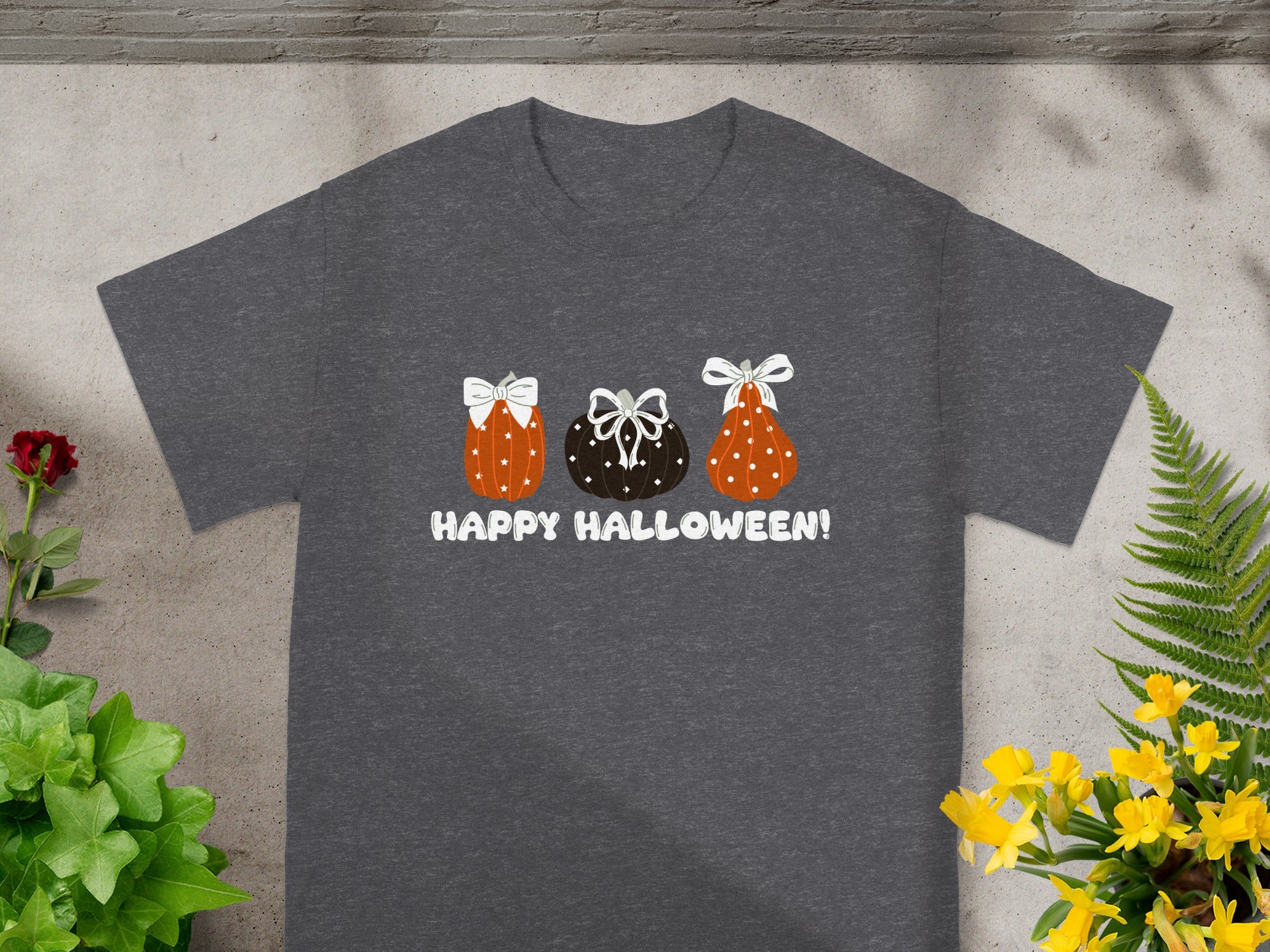 Dark grey t-shirt with three cartoon pumpkins and "HAPPY HALLOWEEN!" text.