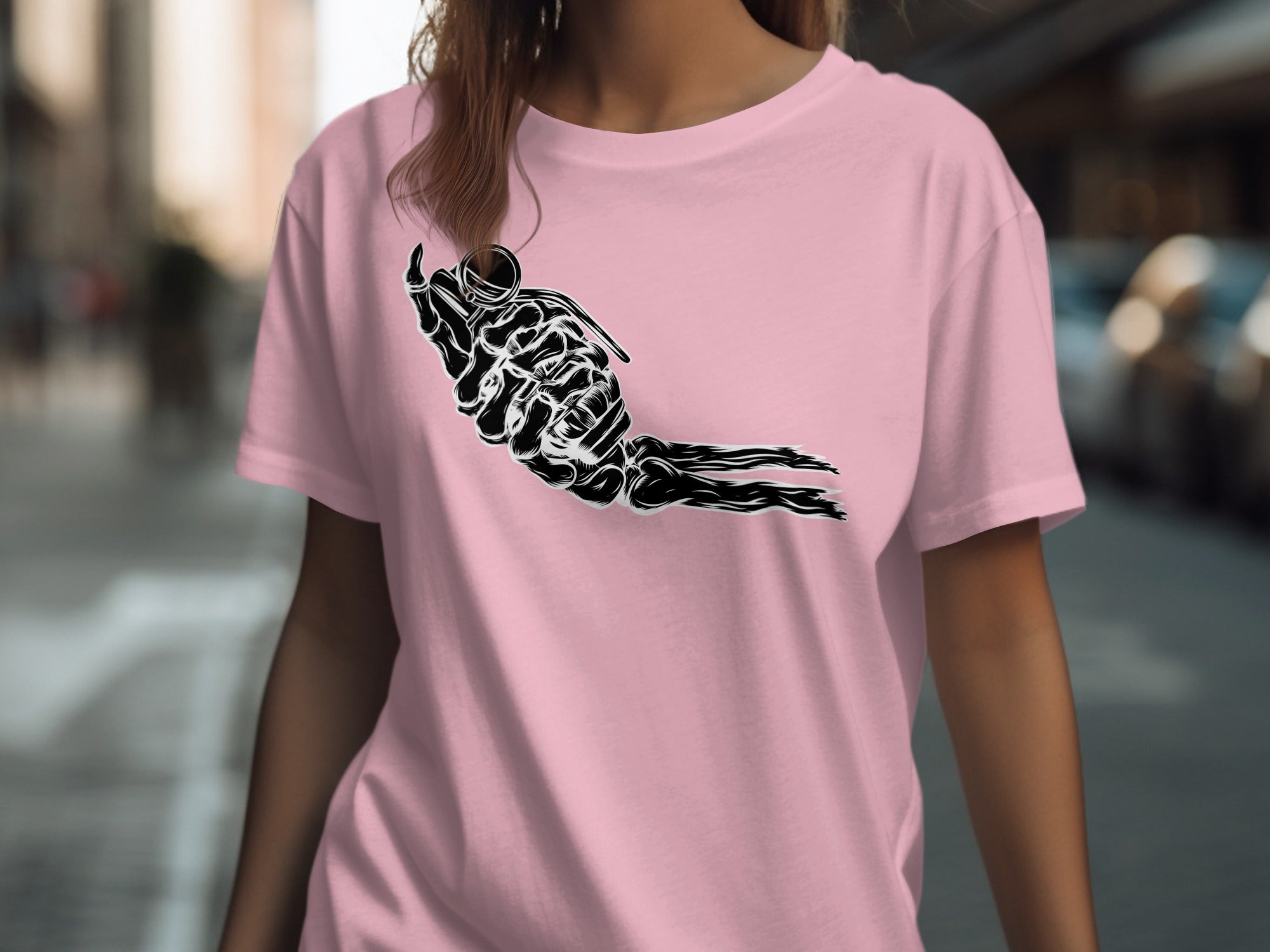 Black skeleton hand holding a grenade on a pink t-shirt.