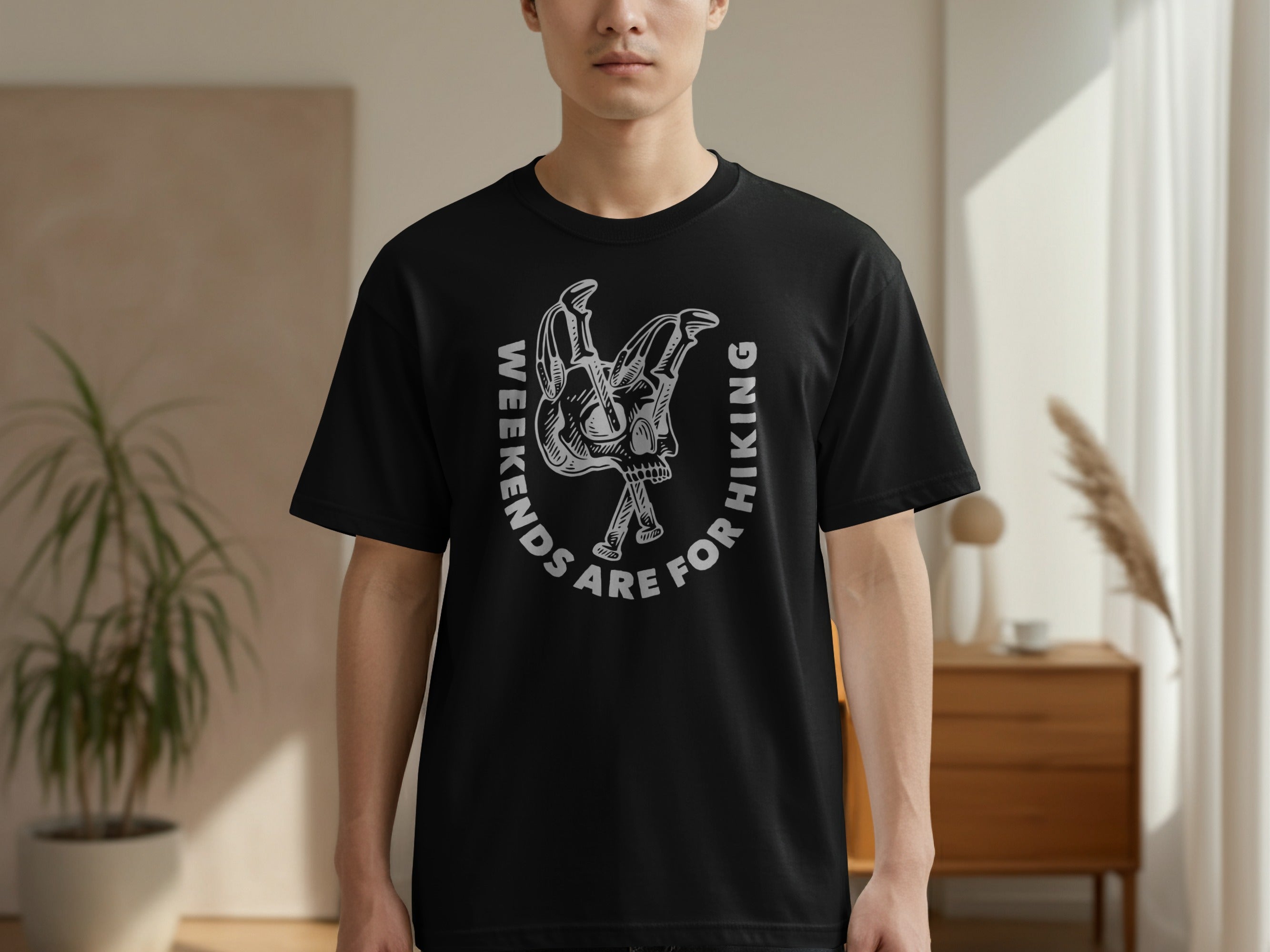 Black t-shirt with a skull and crossed hiking poles graphic and text.