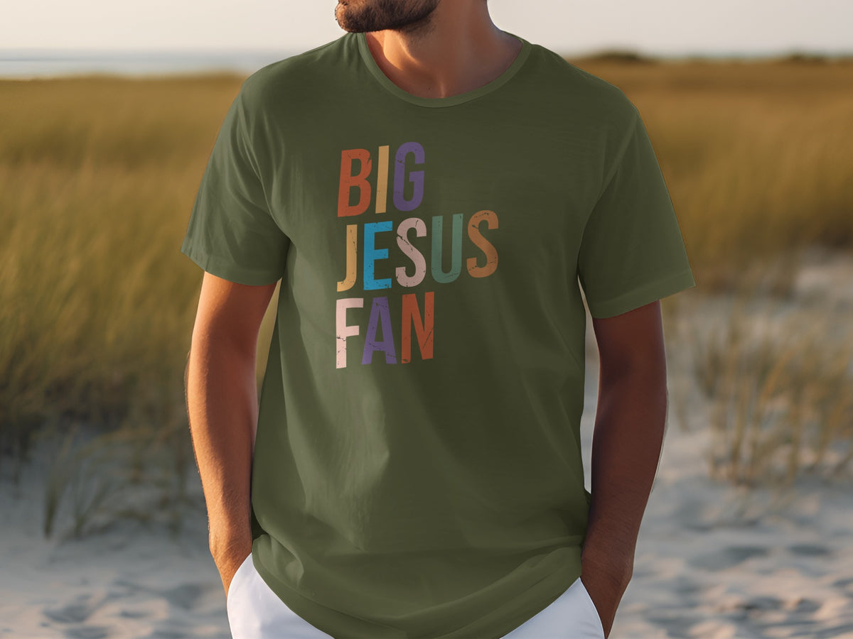 Olive green t-shirt with "BIG JESUS FAN" text in colorful, distressed lettering.