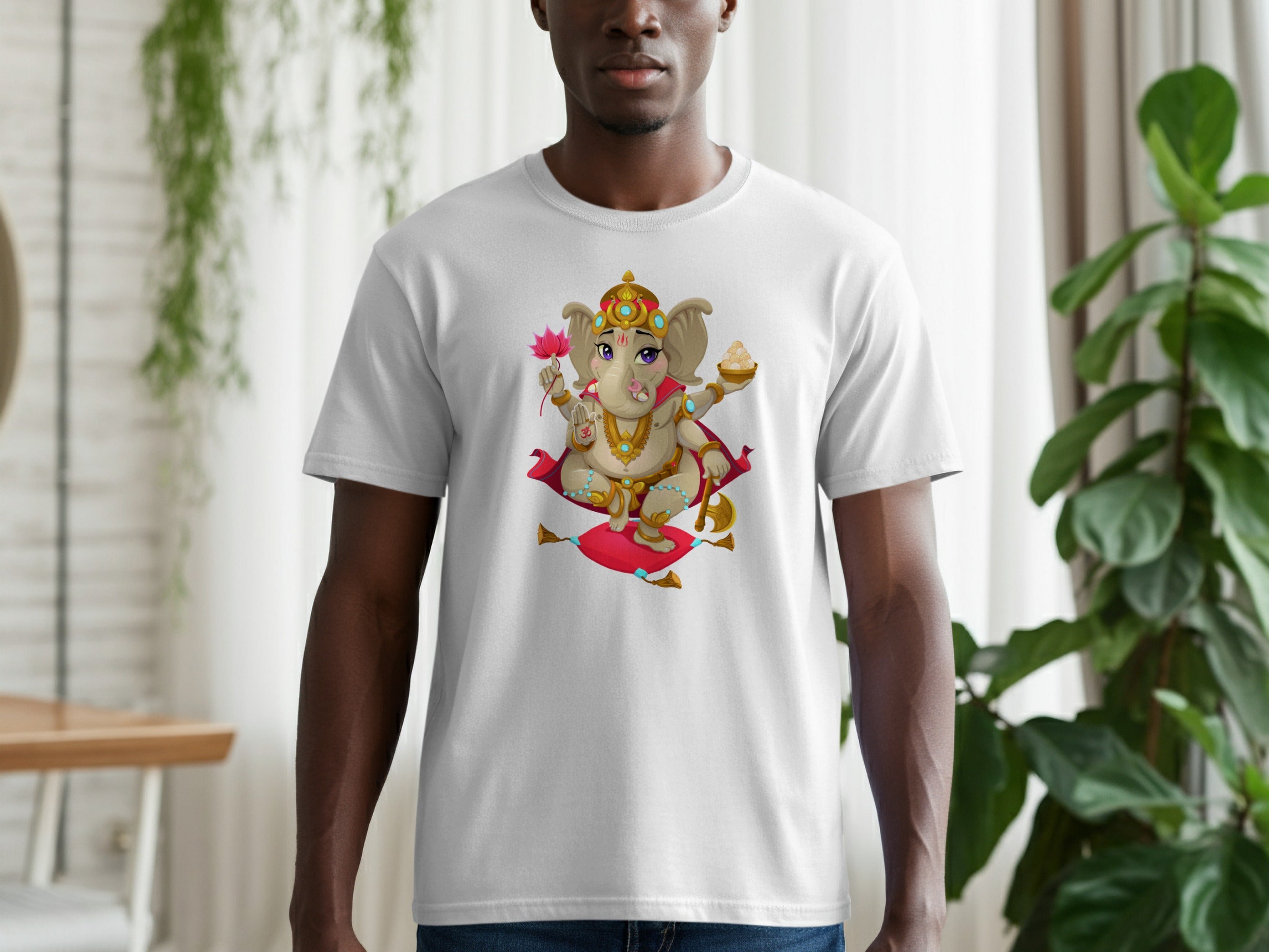 White t-shirt featuring a cartoon Ganesha holding a lotus flower and sweet offering.