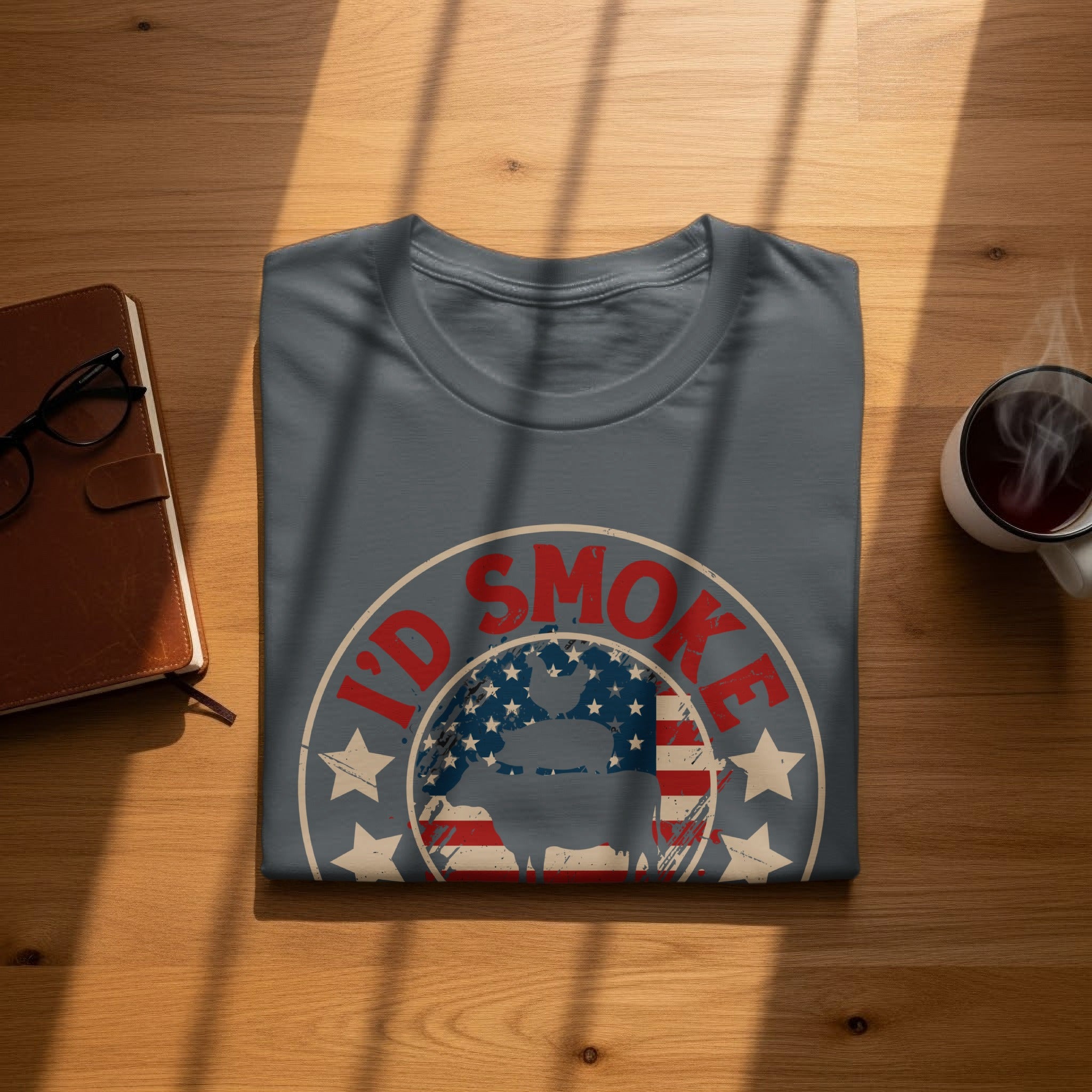 A grey t-shirt with "I'd Smoke" text and a pig silhouette over the US flag.