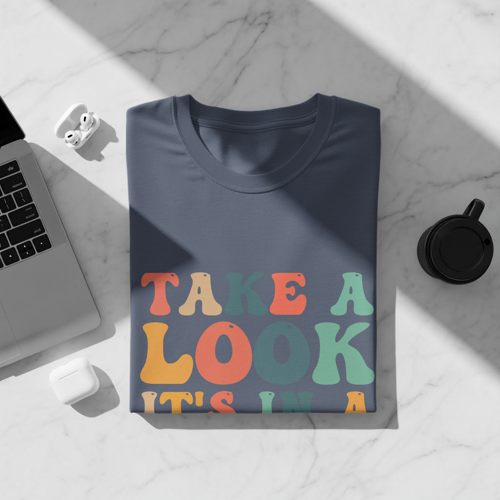 Dark blue t-shirt with text "TAKE A LOOK IT'S IN".