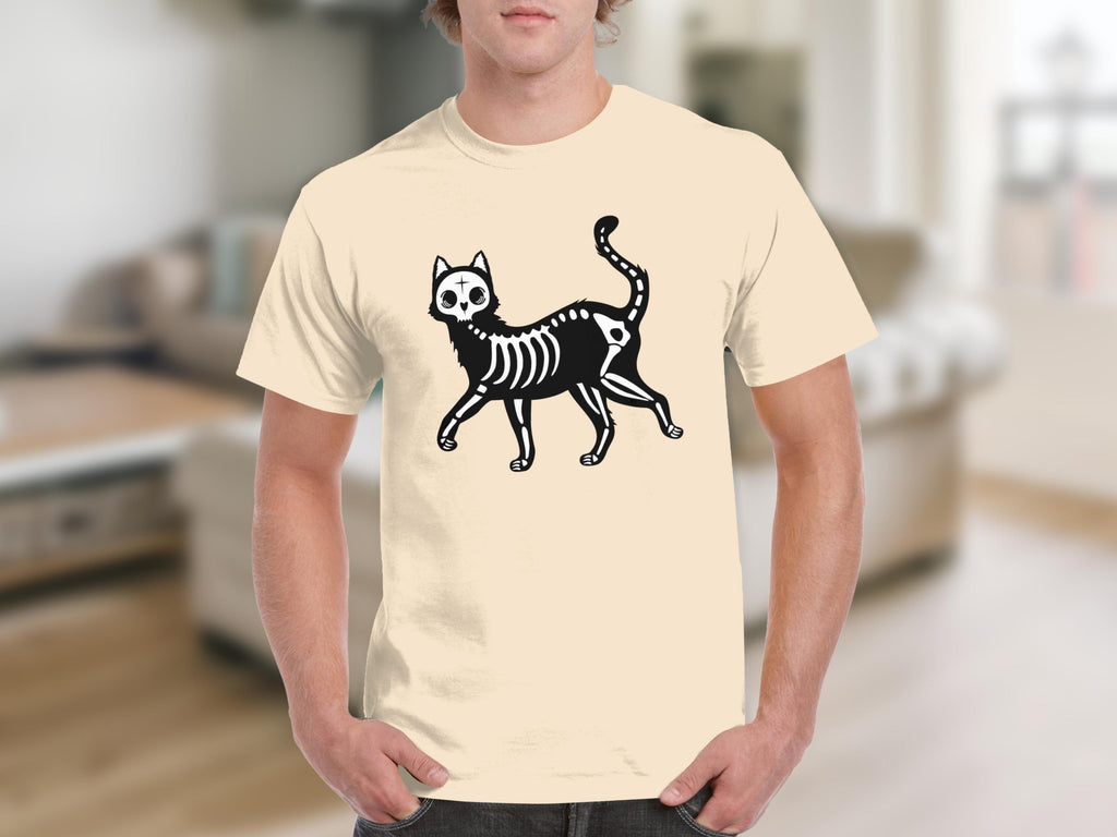 Black skeleton cat graphic on a cream t-shirt worn by a man.