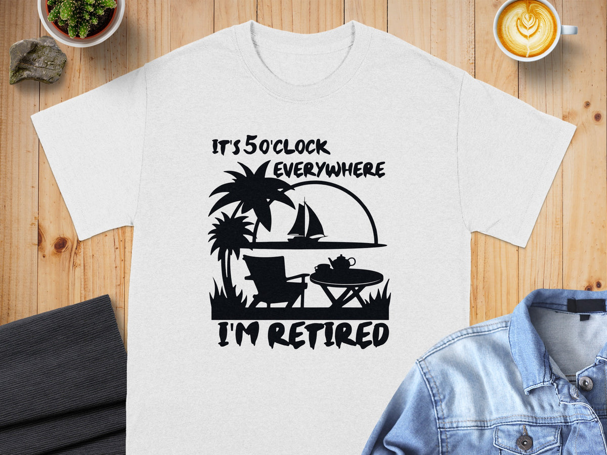 White t-shirt with black graphic: "It's 5 o'clock everywhere. I'm retired."