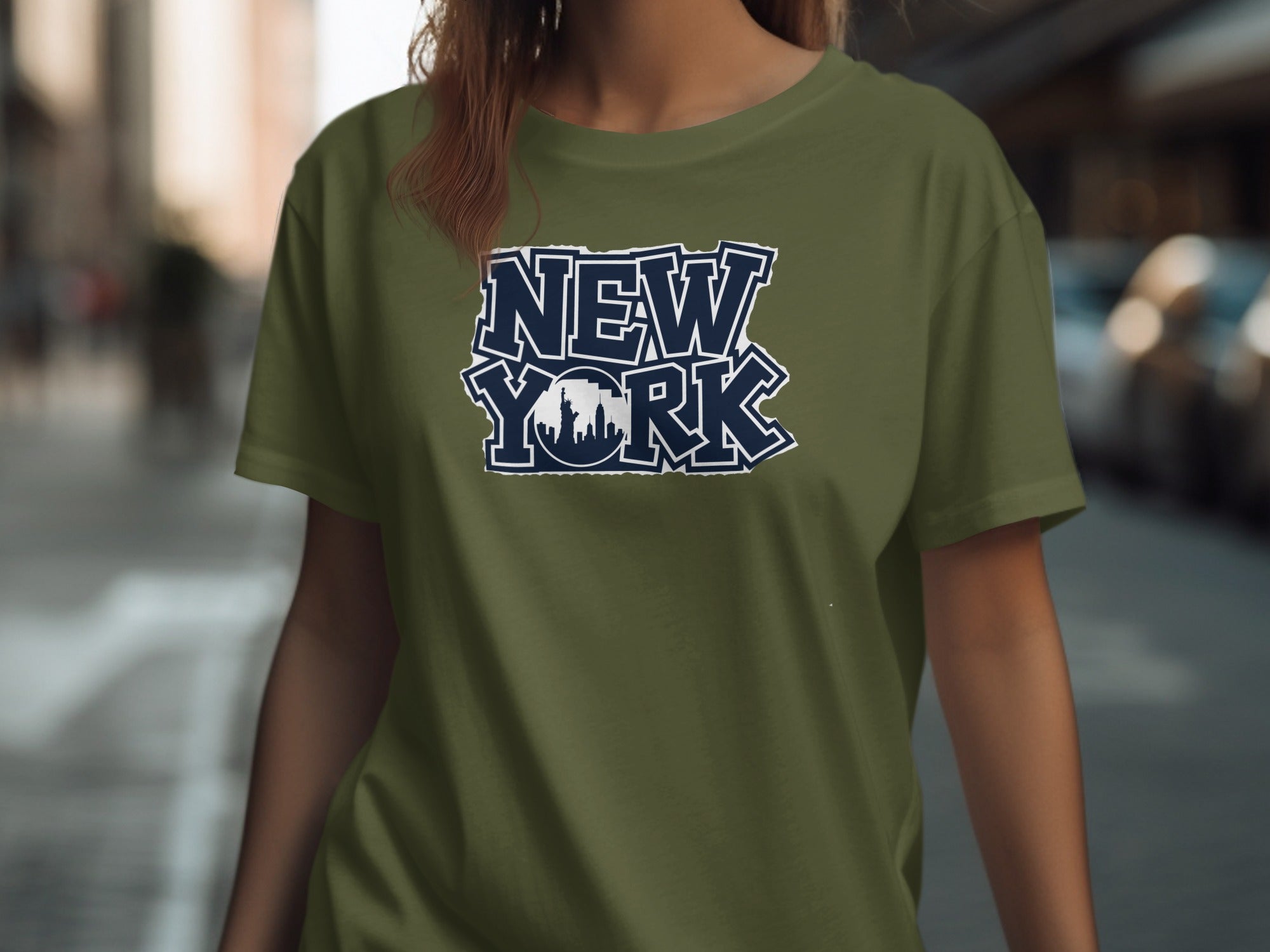 Olive green t-shirt with navy blue "New York" text and skyline graphic.