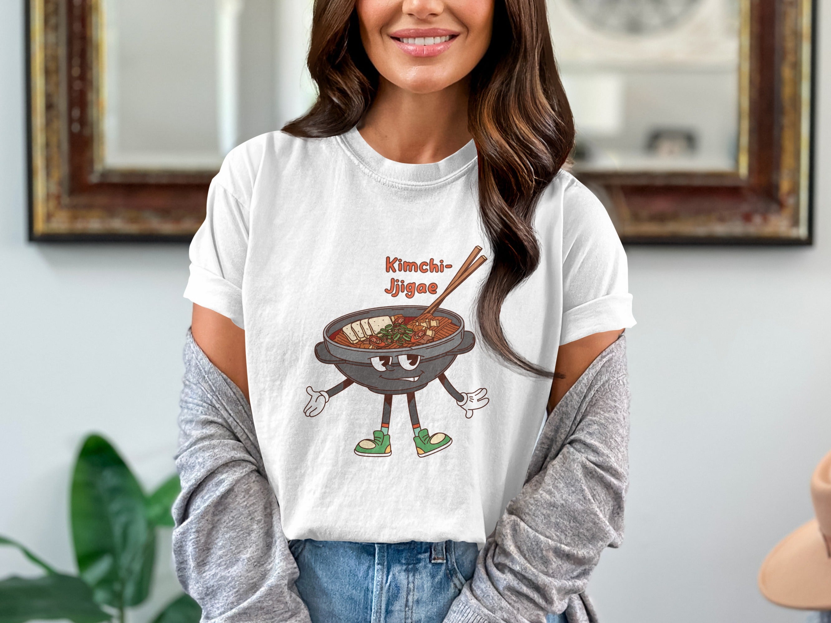 White t-shirt with cartoon Kimchi Jjigae bowl with legs, arms, and happy face.