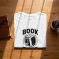 White t-shirt with "BOOK" text and circle of books graphic.