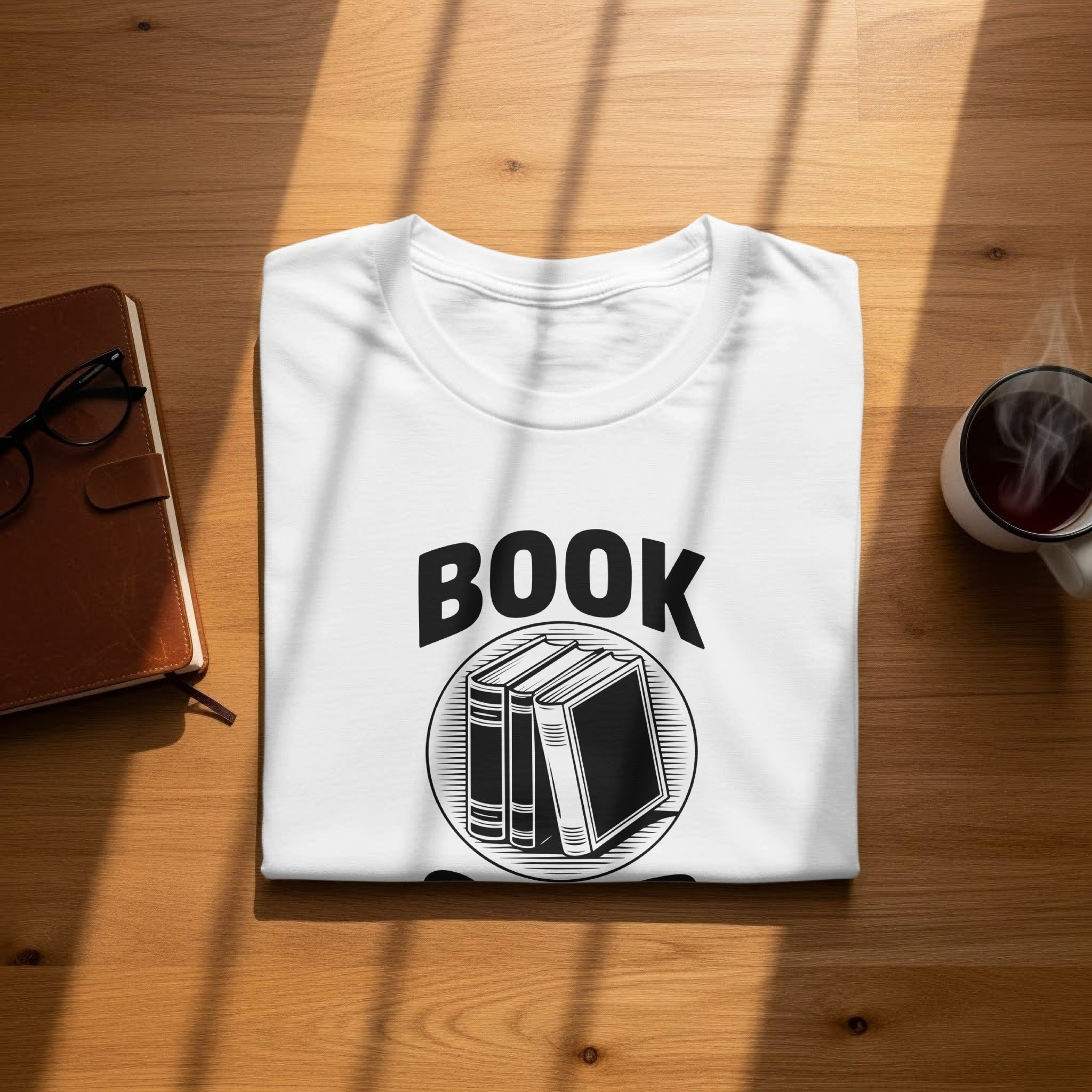 White t-shirt with "BOOK" text and circle of books graphic.