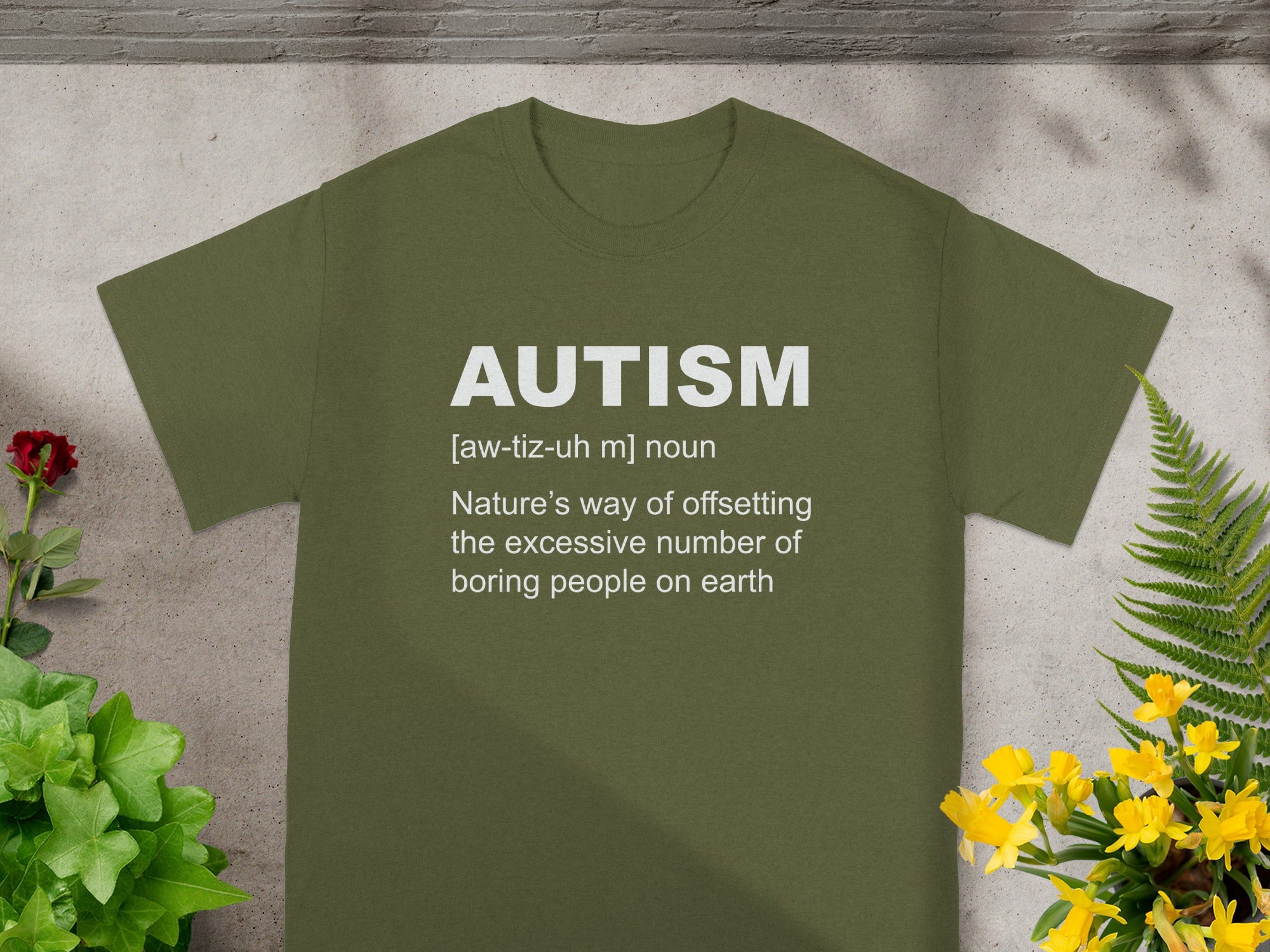 Olive green t-shirt with white text defining "AUTISM".