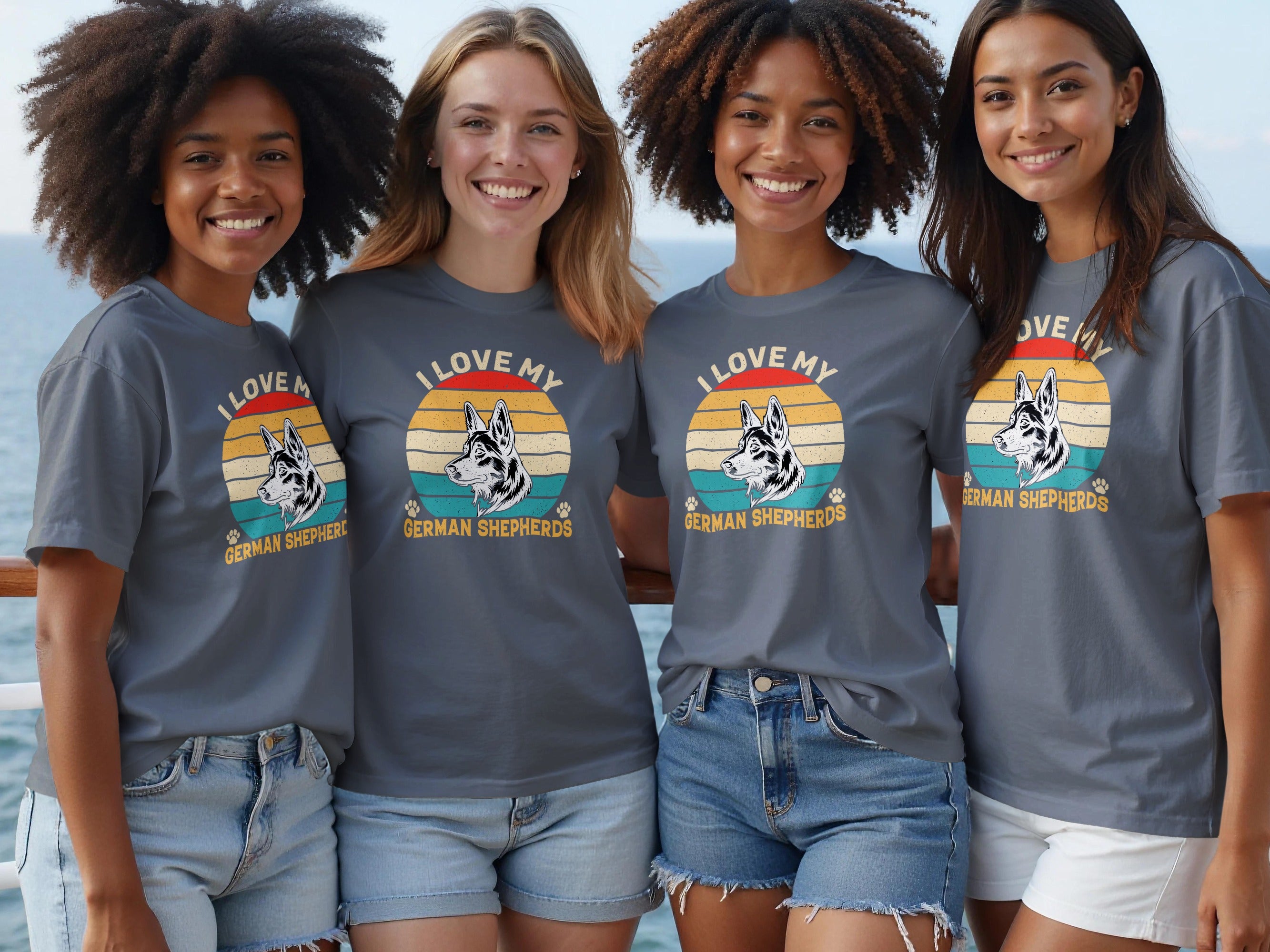 Four women in gray t-shirts featuring a German Shepherd graphic and text.