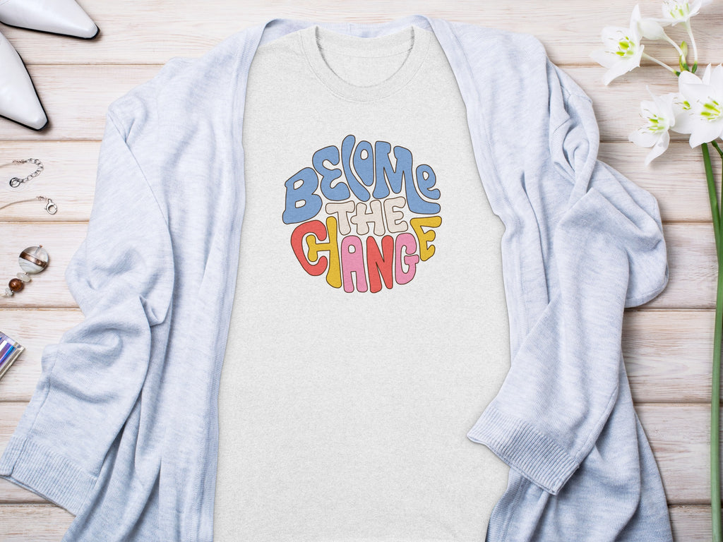 Light gray t-shirt with "Become the Change" text in colorful retro font.