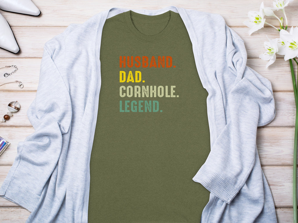 Olive green t-shirt with text "Husband. Dad. Cornhole. Legend."