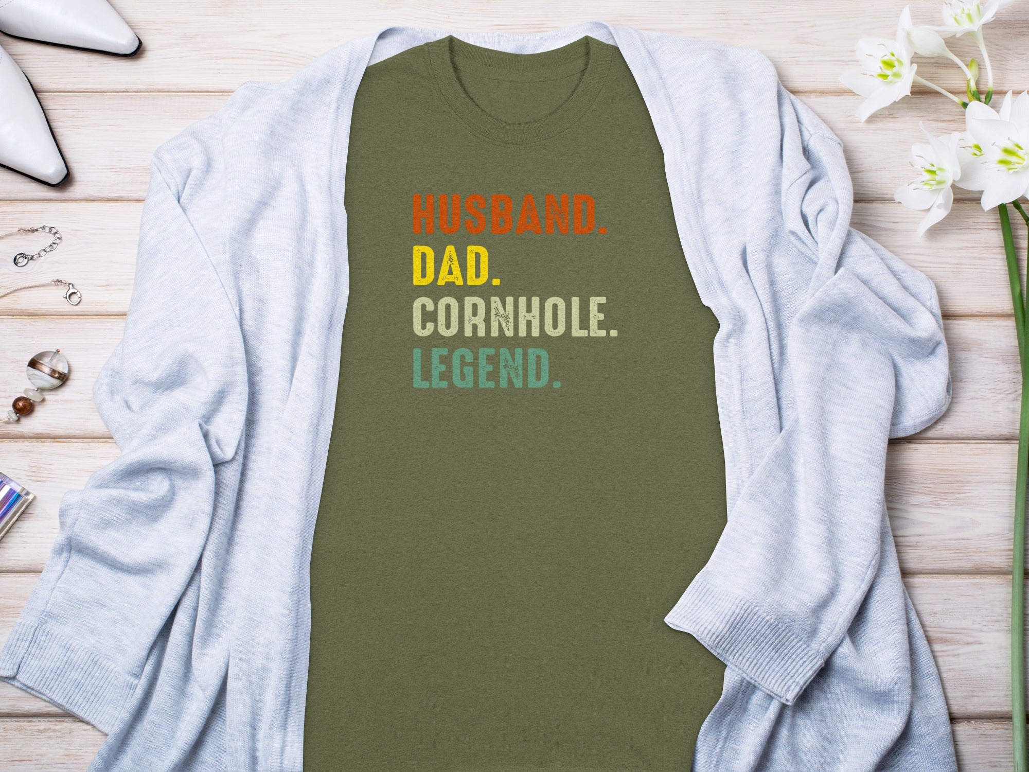 Olive green t-shirt with text "Husband. Dad. Cornhole. Legend."