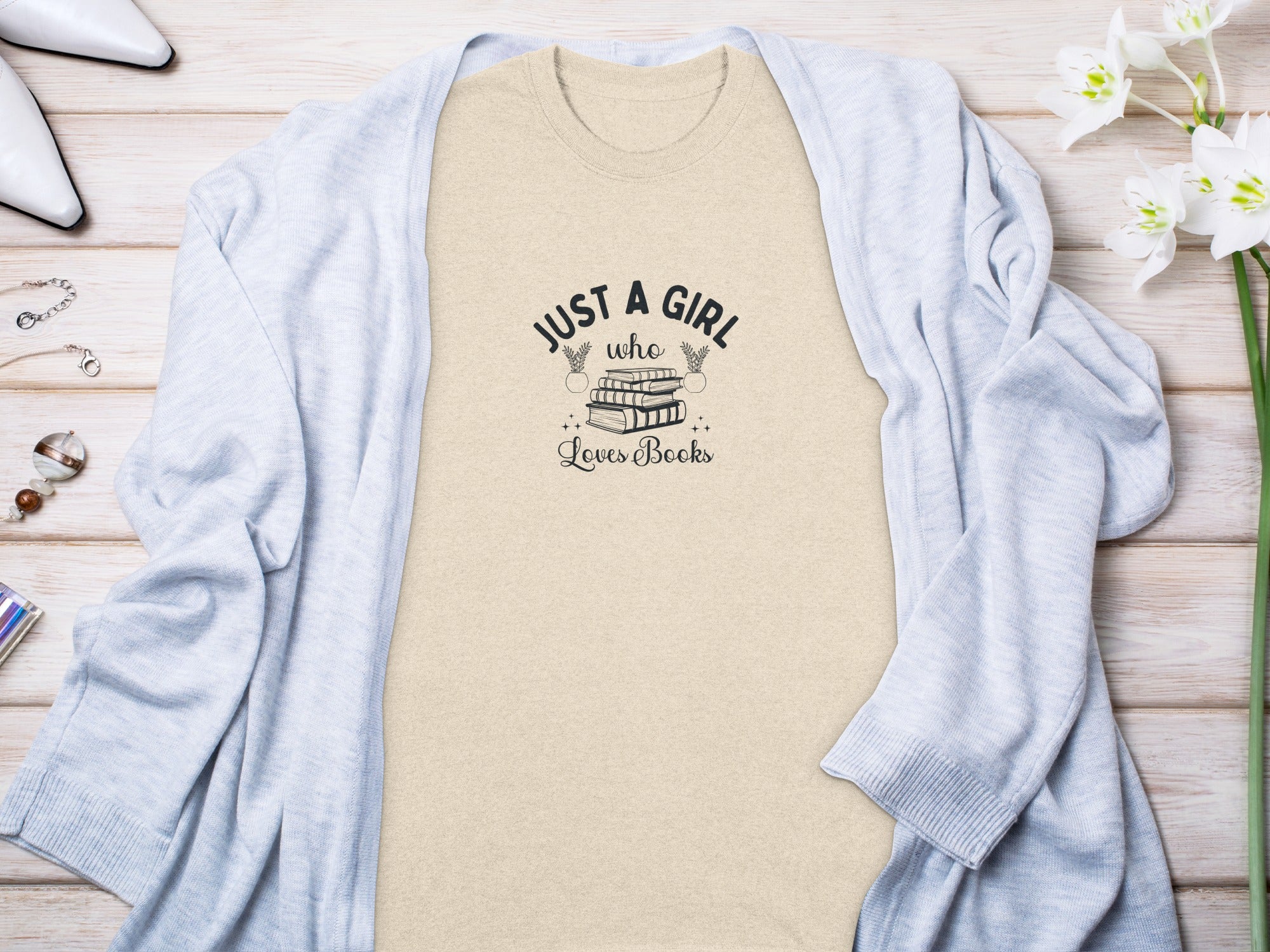 Light-colored t-shirt with "Just a girl who loves books" text graphic