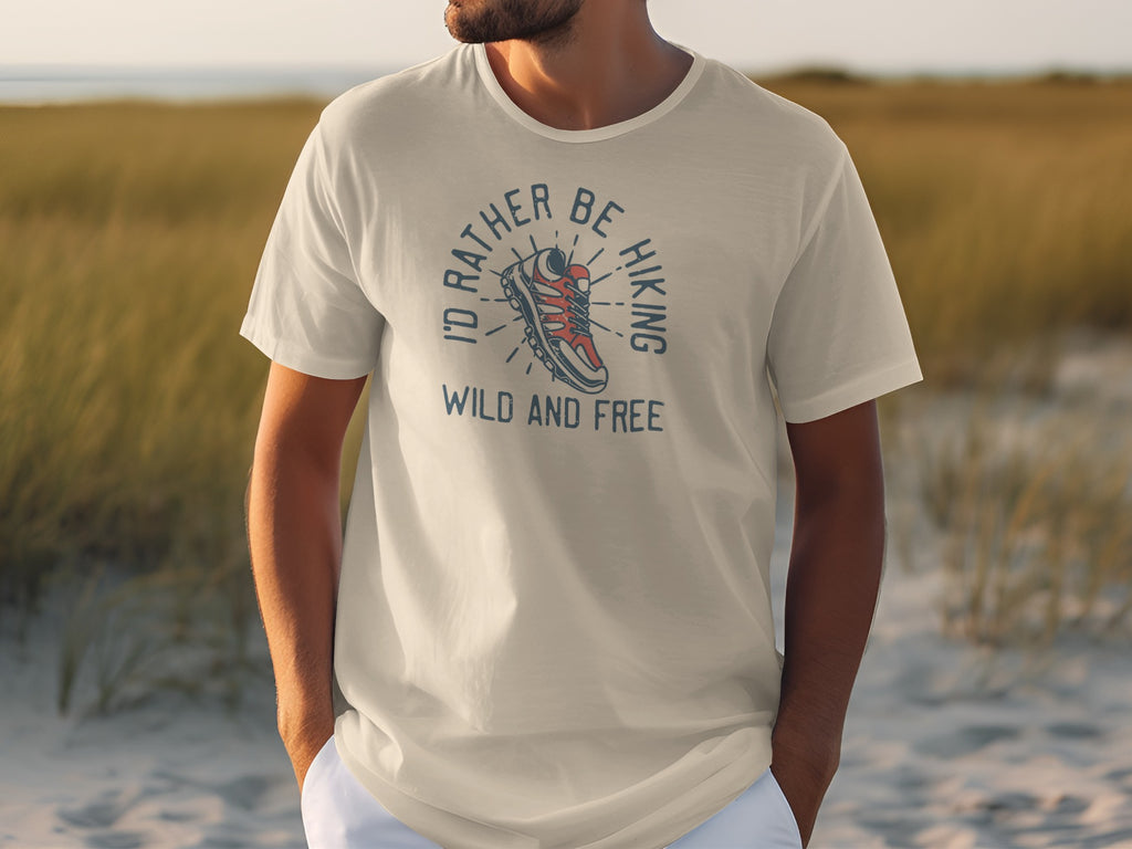 Cream t-shirt with graphic design of hiking boot and text "I'd Rather Be Hiking Wild and Free".