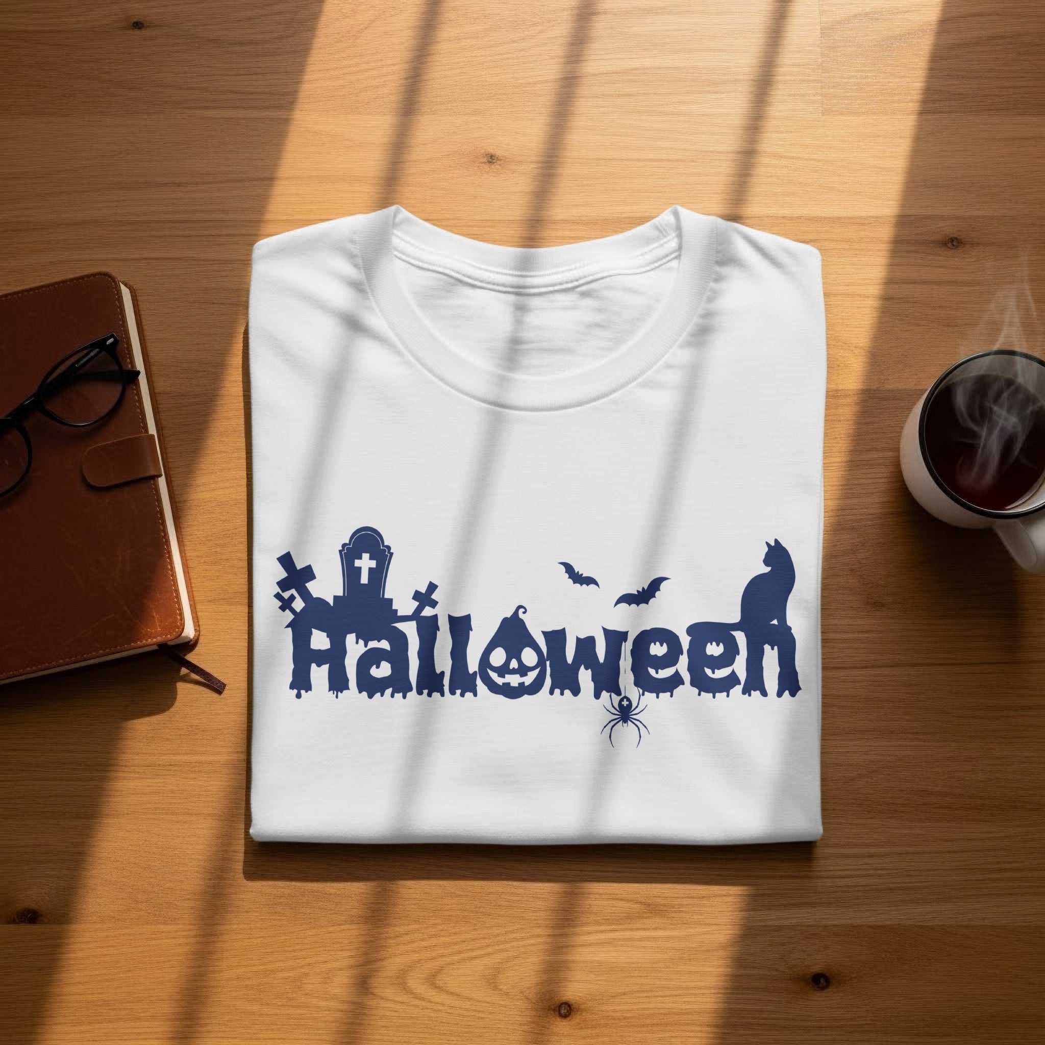 White t-shirt with blue Halloween graphic featuring cemetery and cat.