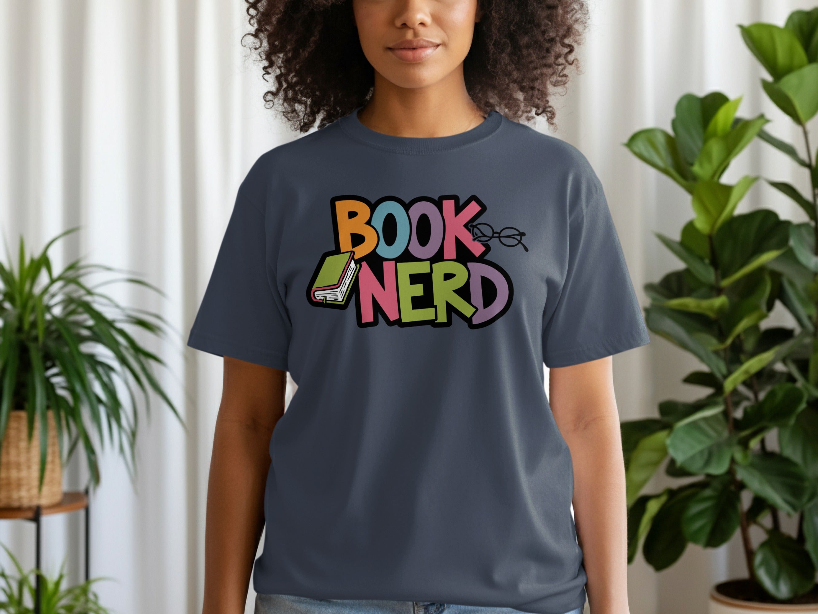 Dark blue t-shirt with colorful "BOOK NERD" text, a book, and glasses graphic.