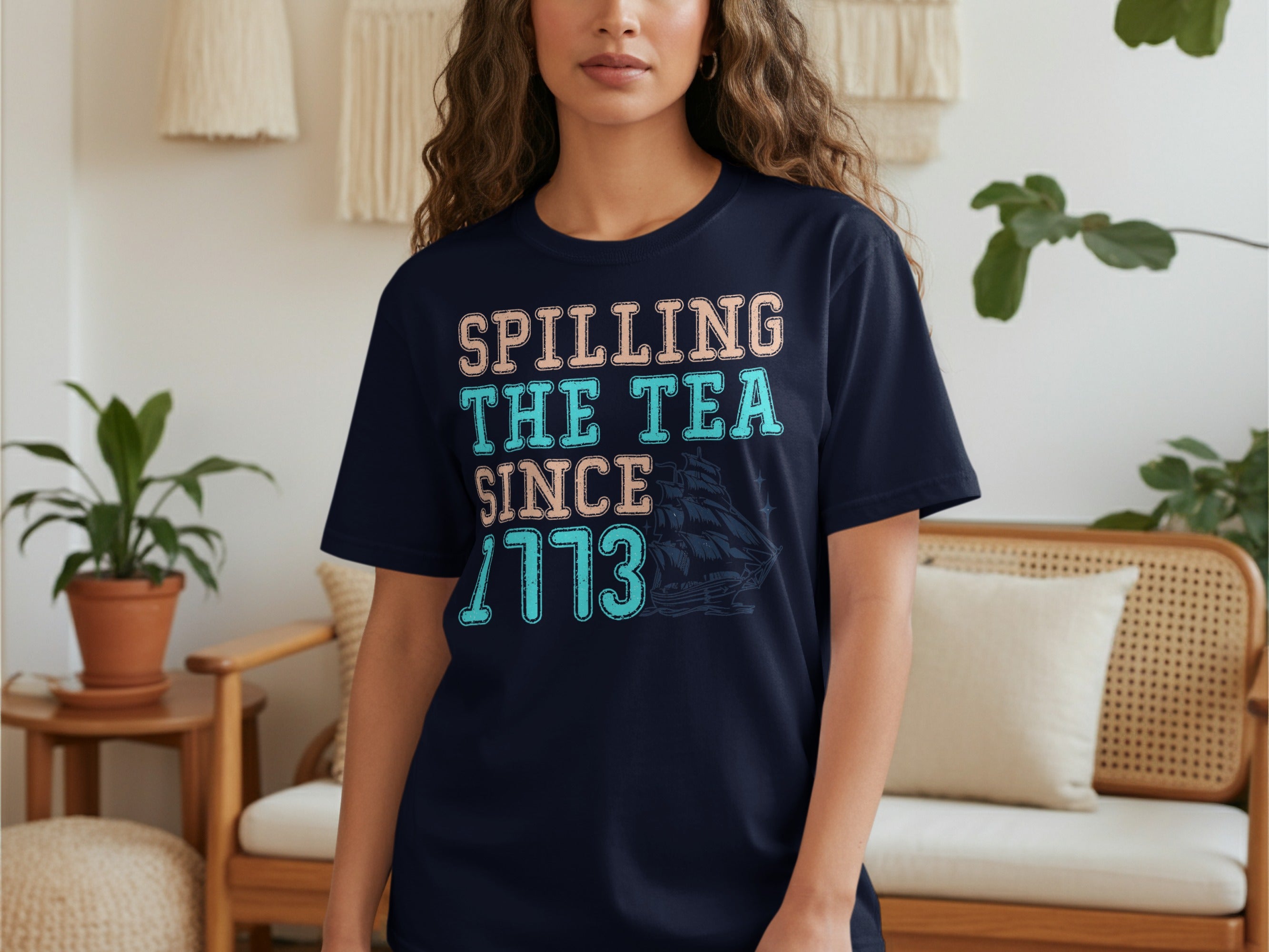 Navy t-shirt with "Spilling The Tea Since 1773" text and ship graphic.