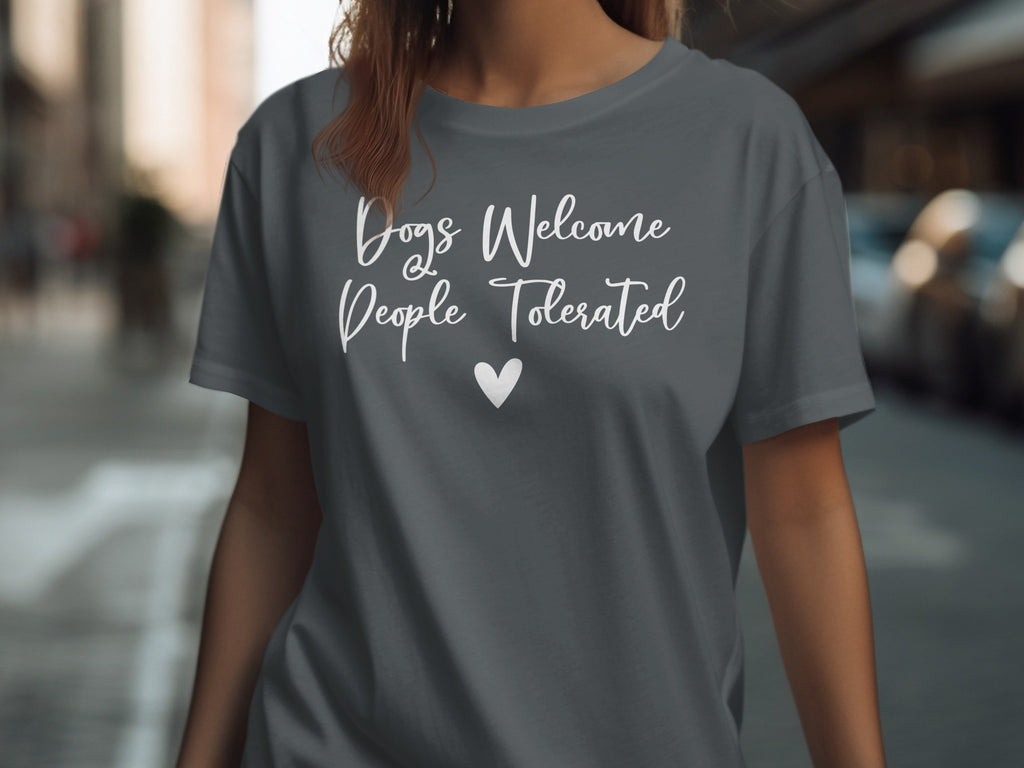 Gray t-shirt with white text that says "Dogs Welcome, People Tolerated" and a heart.