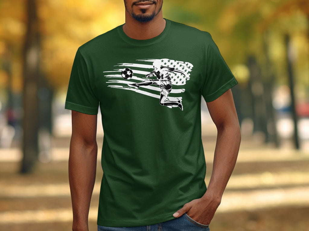 Green t-shirt with graphic of soccer player kicking ball with stars and stripes flag behind.