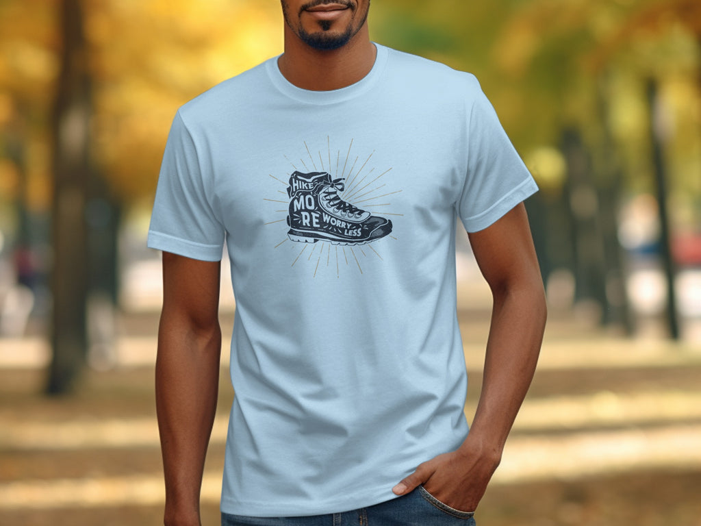 Light blue t-shirt with graphic of hiking boot and text "hike more, worry less."