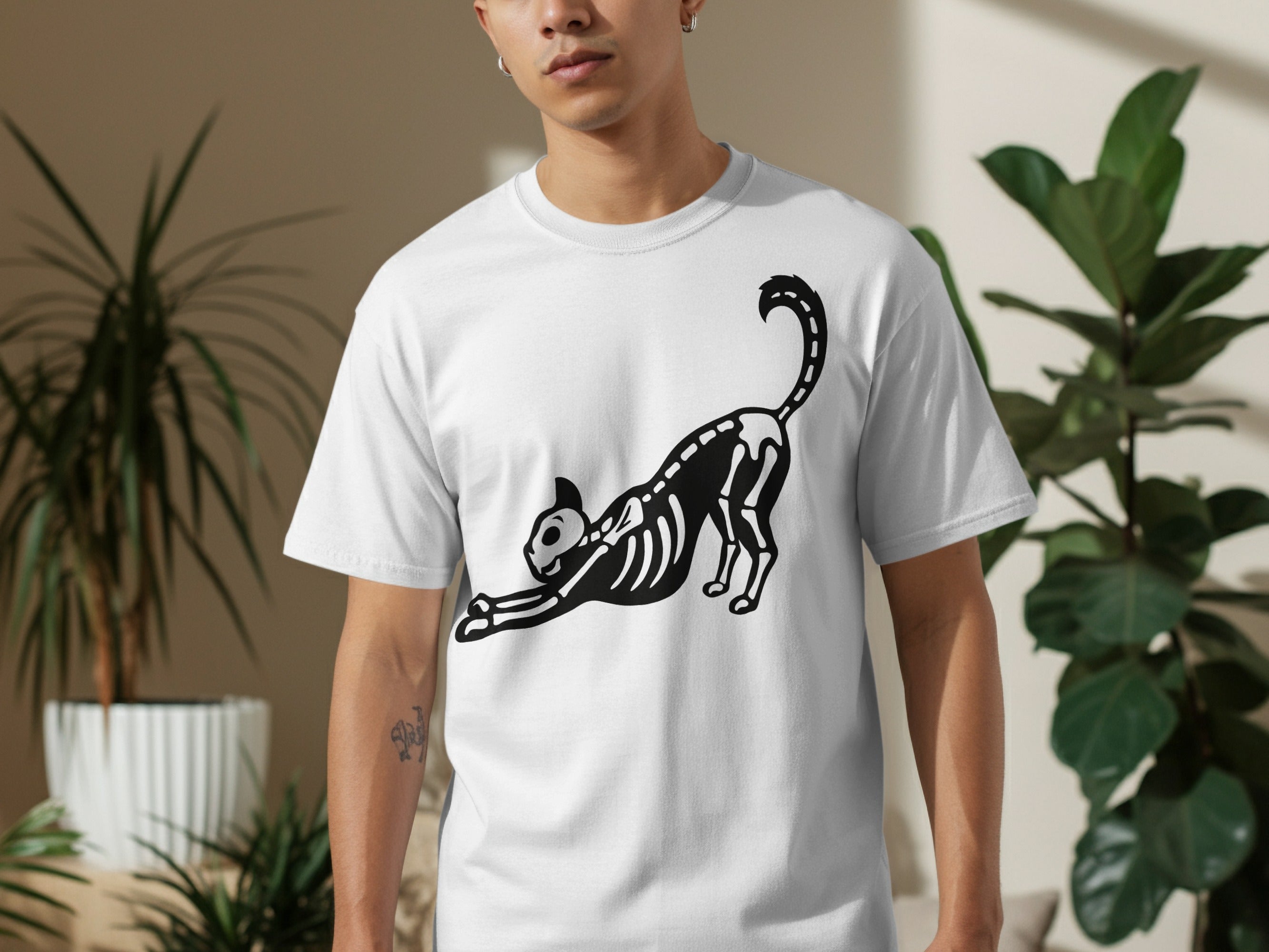 White t-shirt with a black skeleton cat stretching design.