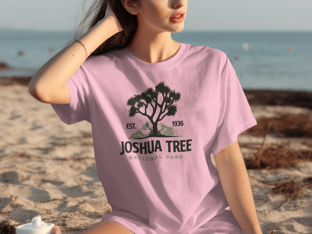 Pink t-shirt with Joshua Tree National Park logo, including a tree silhouette, mountains, and text.