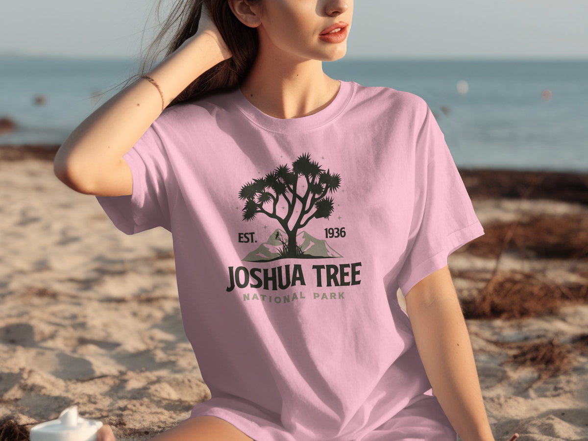 Pink t-shirt with Joshua Tree National Park logo, including a tree silhouette, mountains, and text.