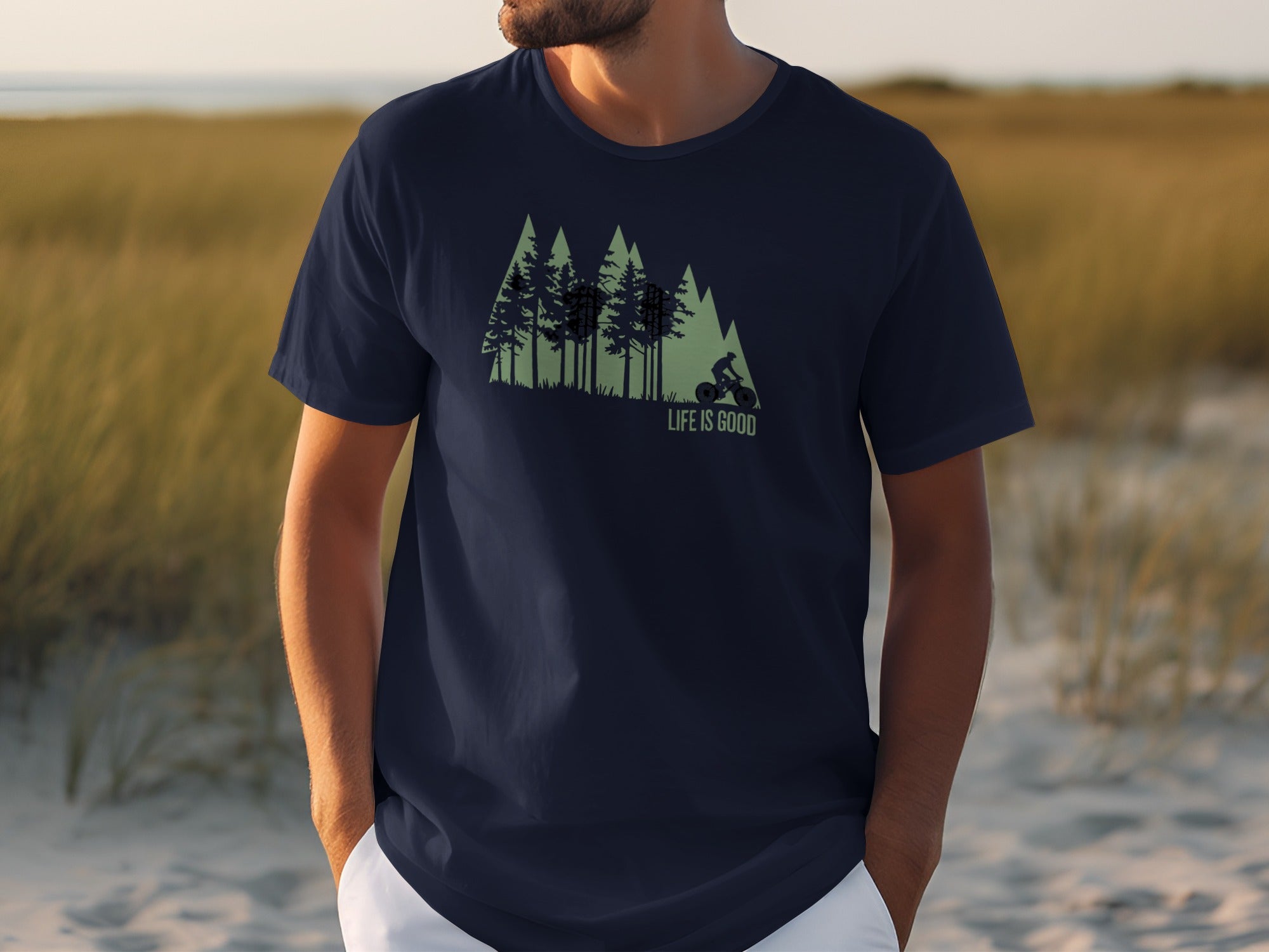 Navy t-shirt with forest graphic and "LIFE IS GOOD" text.