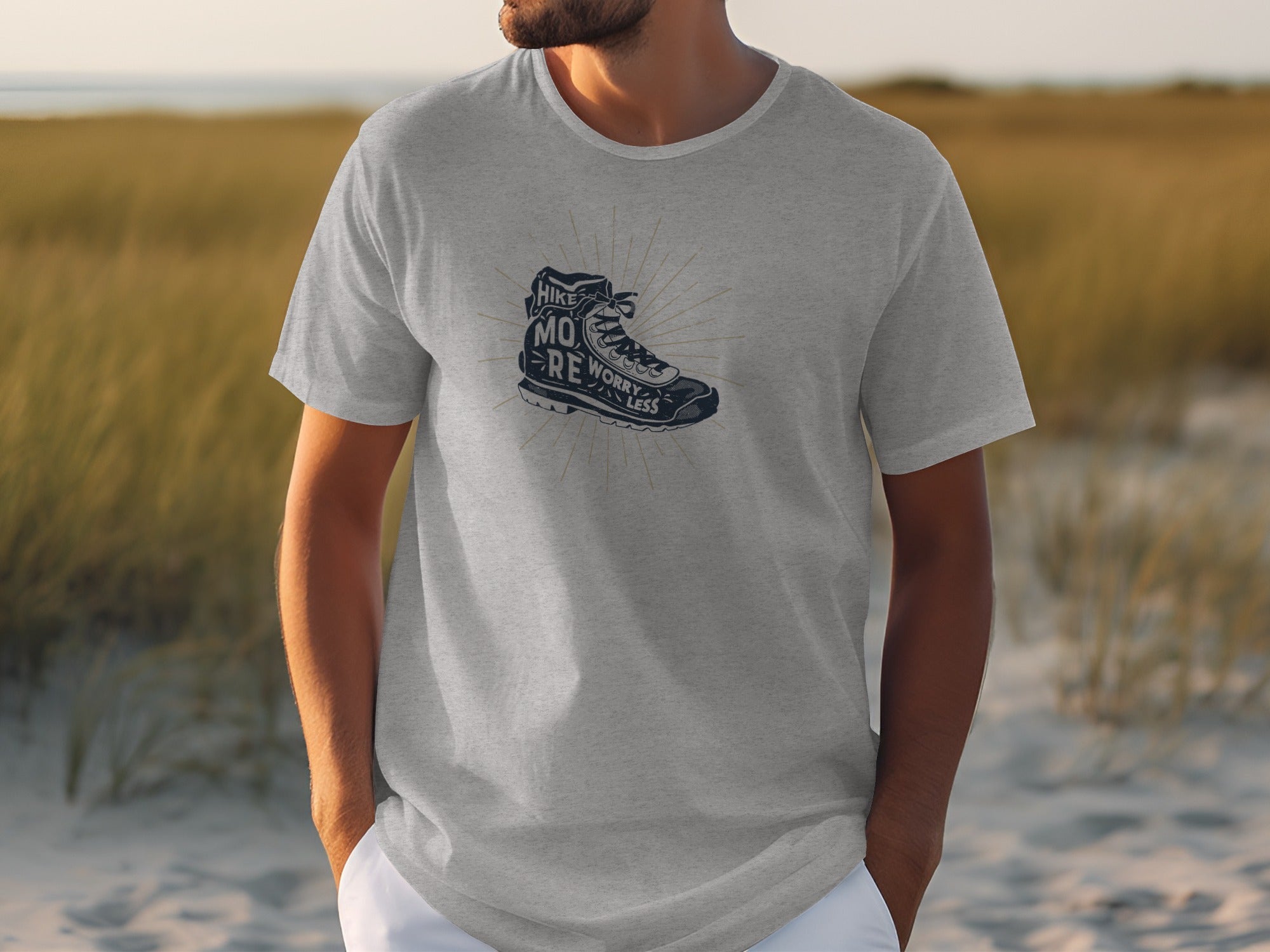 Grey t-shirt with graphic of hiking boot and text "Hike More Worry Less".