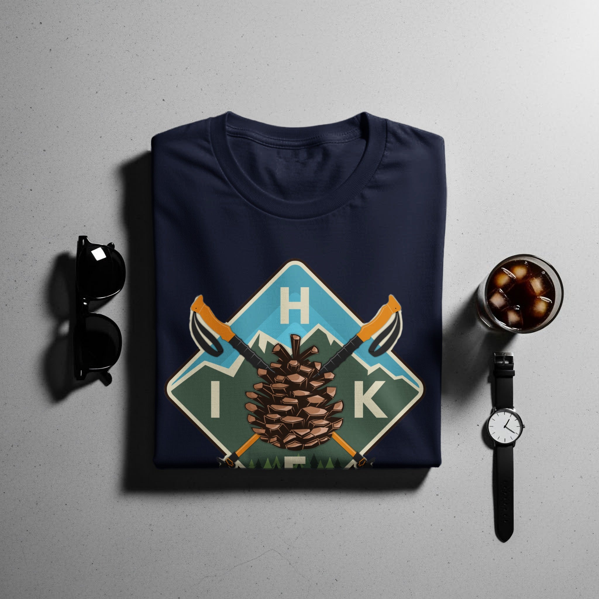 Navy t-shirt with a pinecone, hiking poles, and "I H K" graphic.