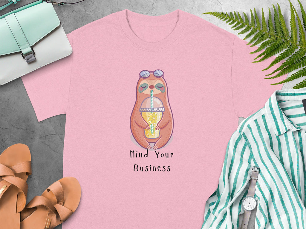 Pink t-shirt with a sloth wearing sunglasses holding a lemonade and text "Mind Your Business".