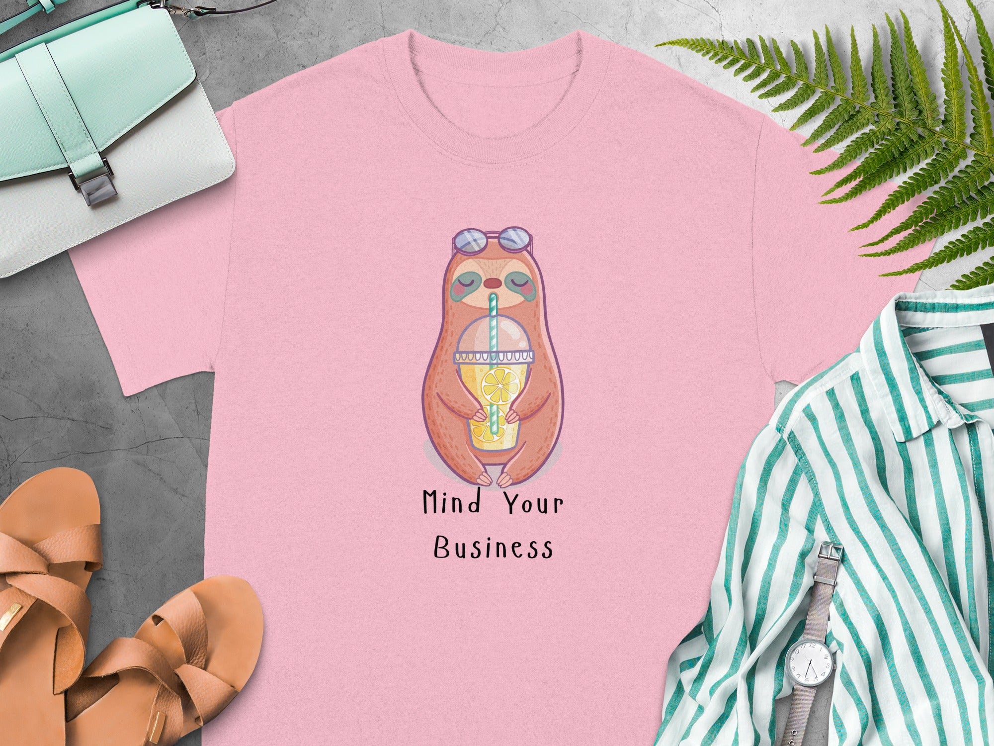 Pink t-shirt with a sloth wearing sunglasses holding a lemonade and text "Mind Your Business".