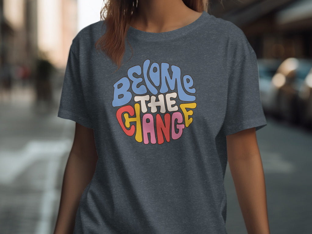 Dark grey t-shirt with "BECOME THE CHANGE" text in colorful retro lettering.