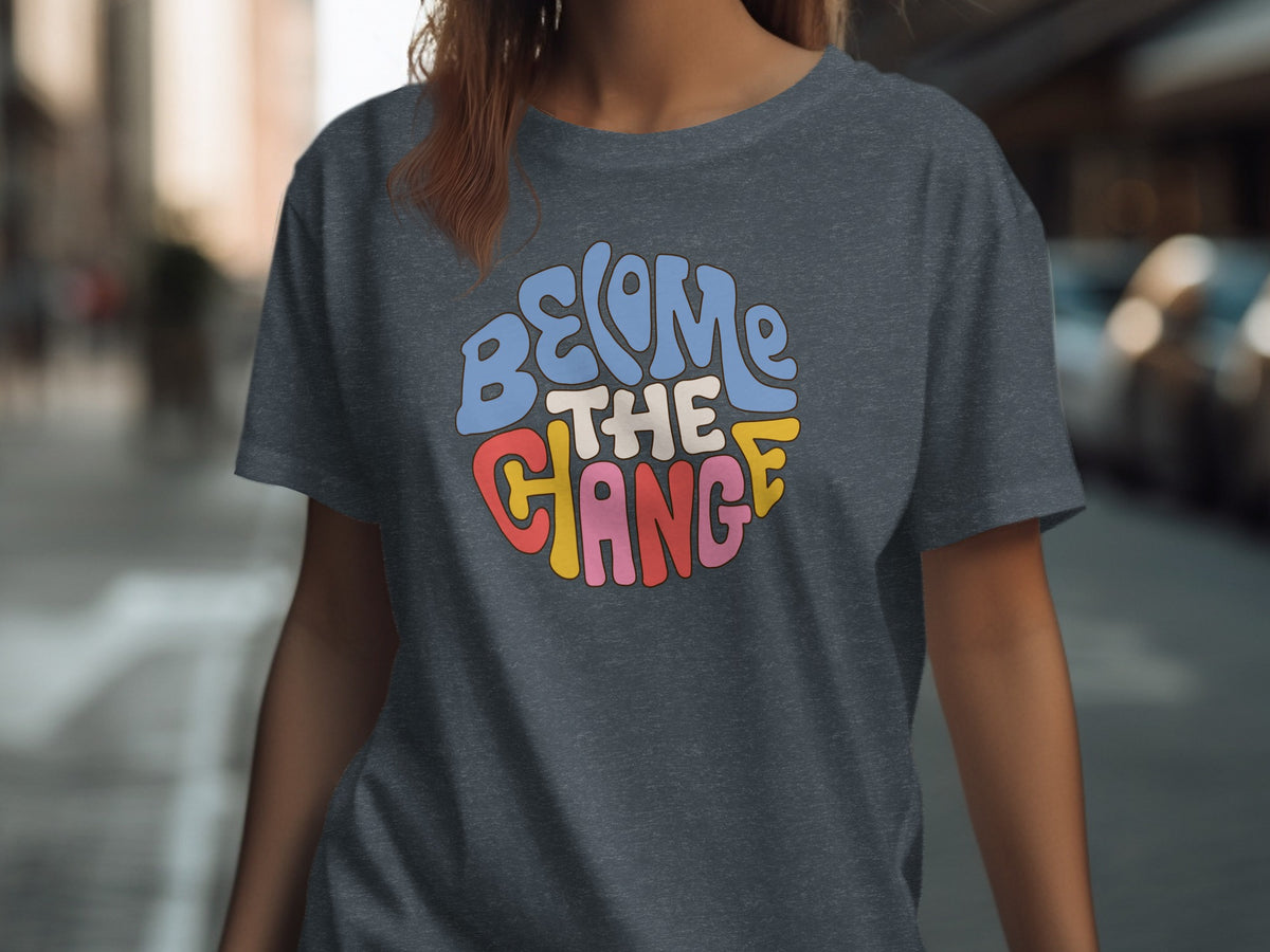 Dark grey t-shirt with "BECOME THE CHANGE" text in colorful retro lettering.