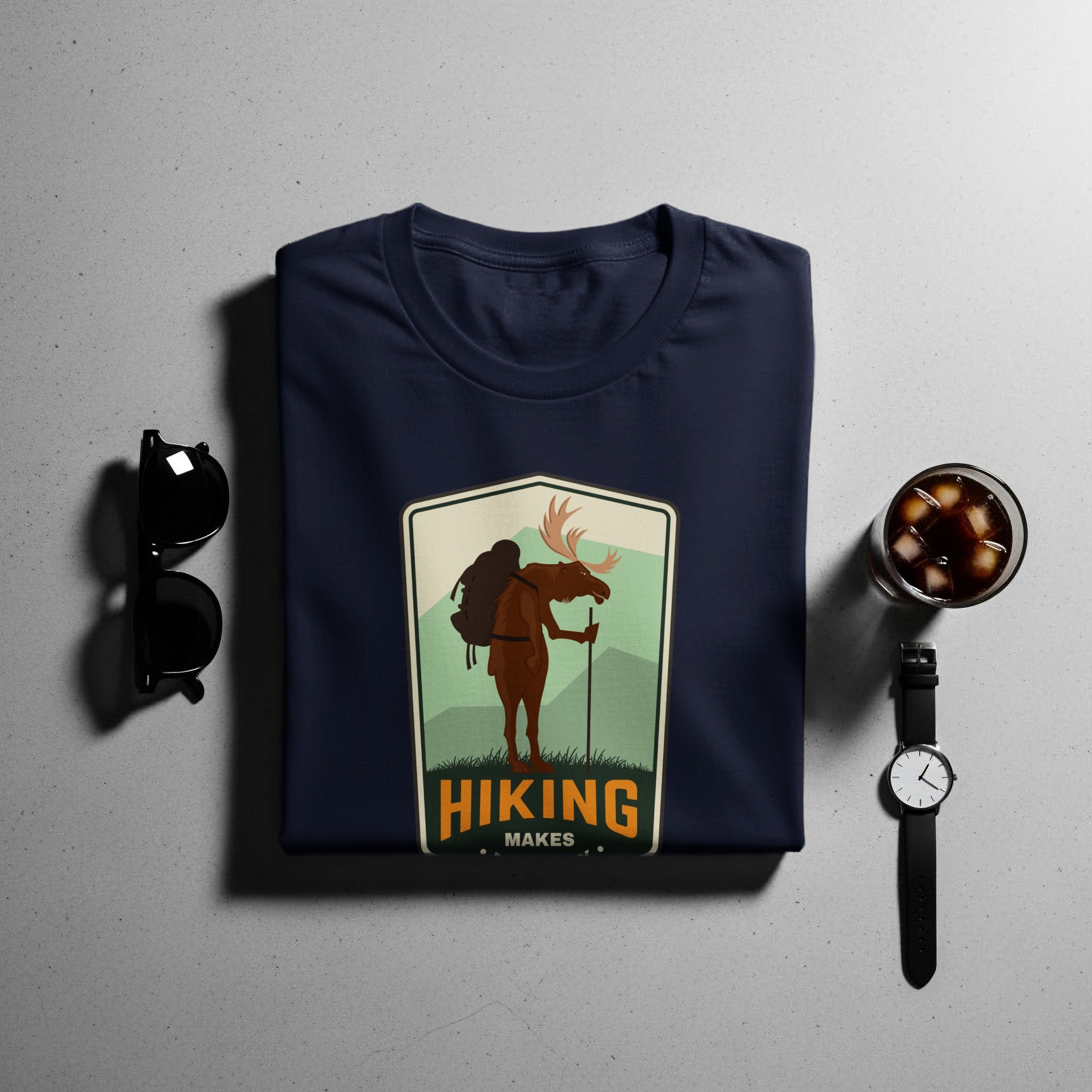 Navy t-shirt with a hiking moose emblem and "HIKING MAKES" text.