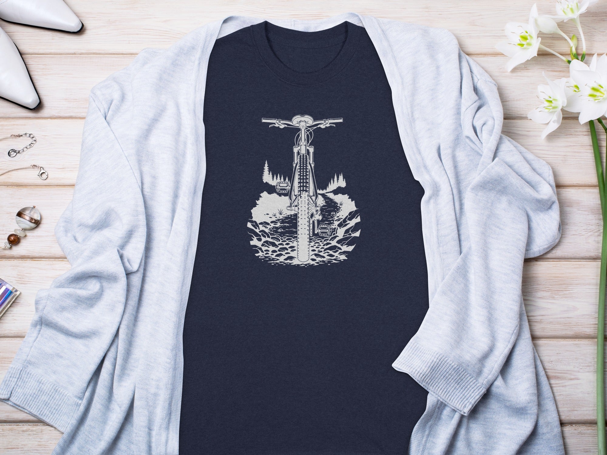 Navy t-shirt with white mountain bike, trees, and rocky terrain graphic.