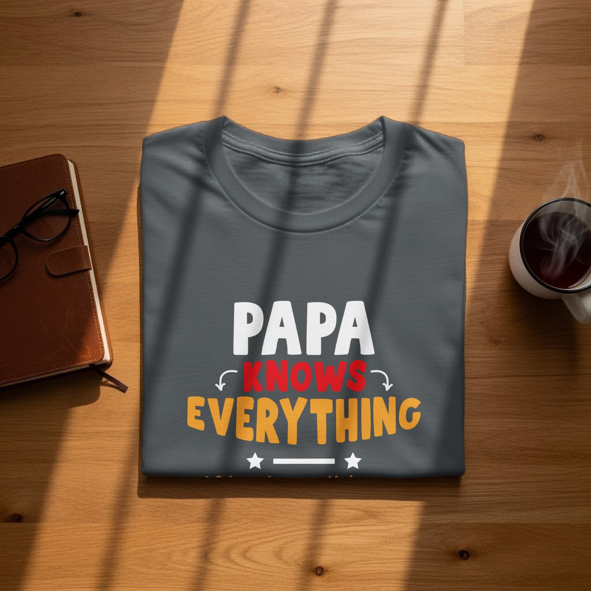 Dark gray t-shirt with "PAPA KNOWS EVERYTHING" text in white, red, and orange.
