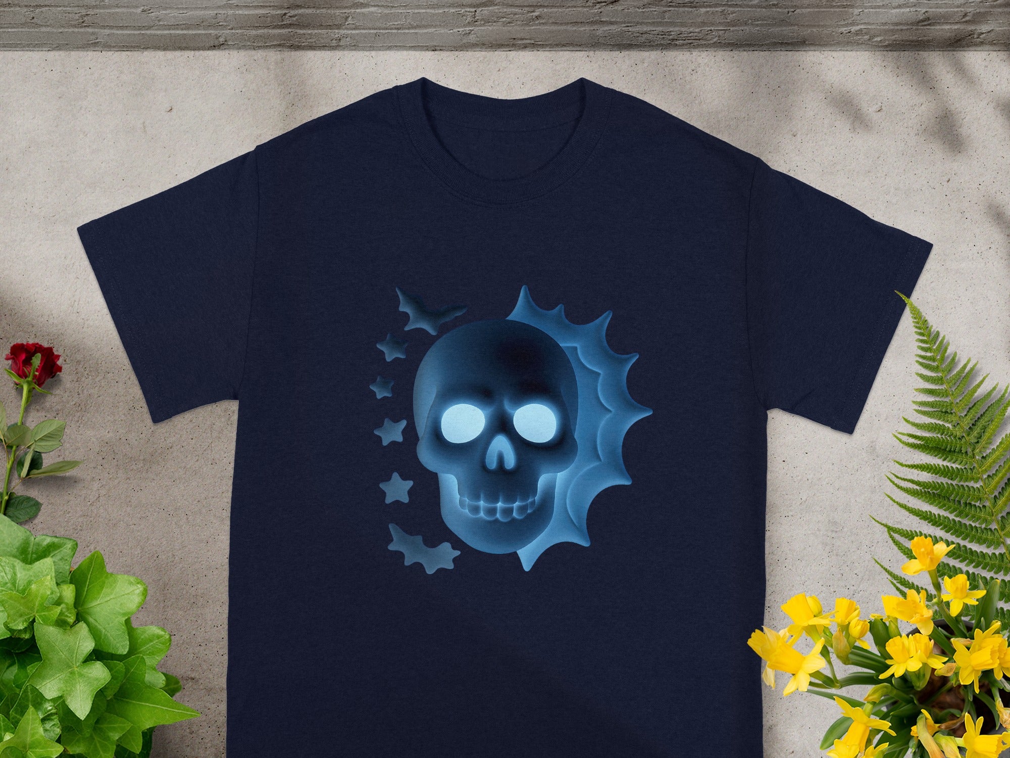 Navy t-shirt with glowing blue skull and bats graphic.