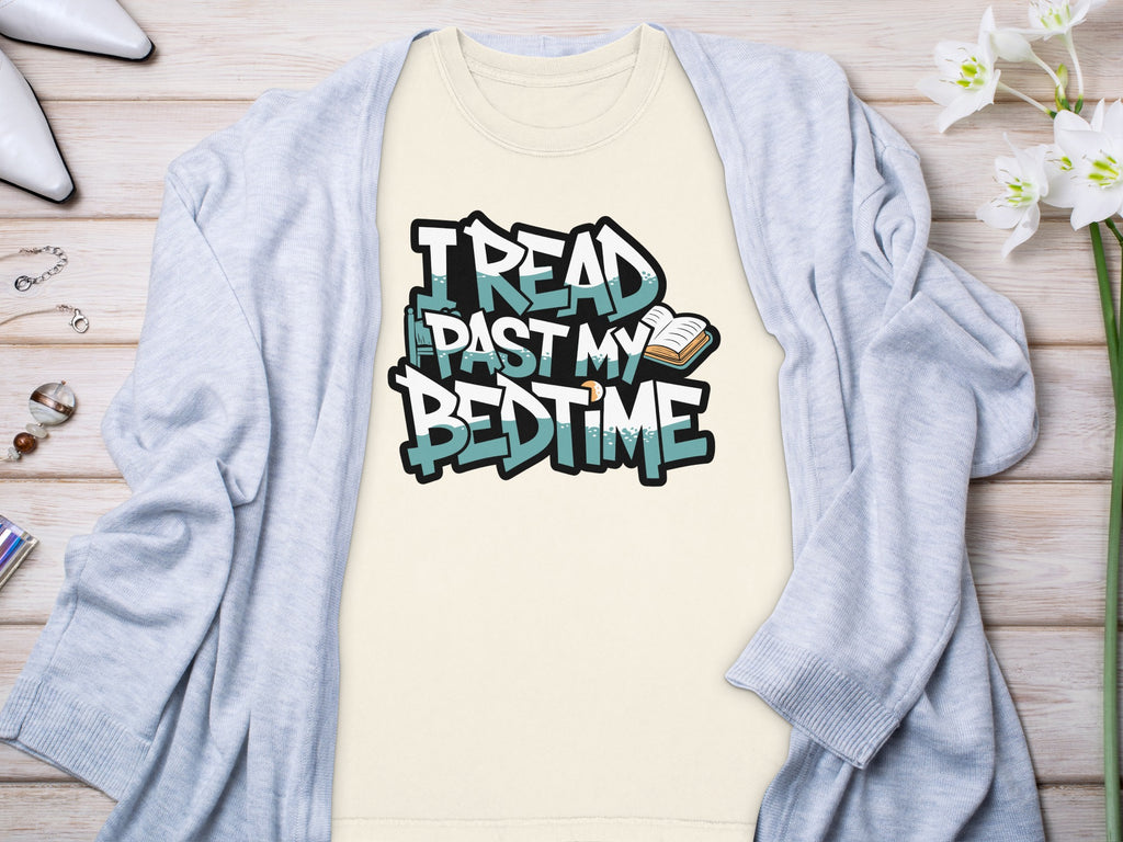 Cream t-shirt with "I read past my bedtime" graphic and an open book.