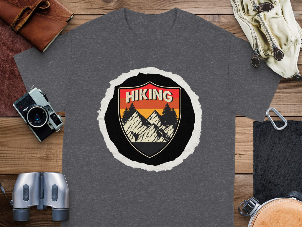 Dark grey t-shirt with a distressed circular design of mountains and text that reads "HIKING".