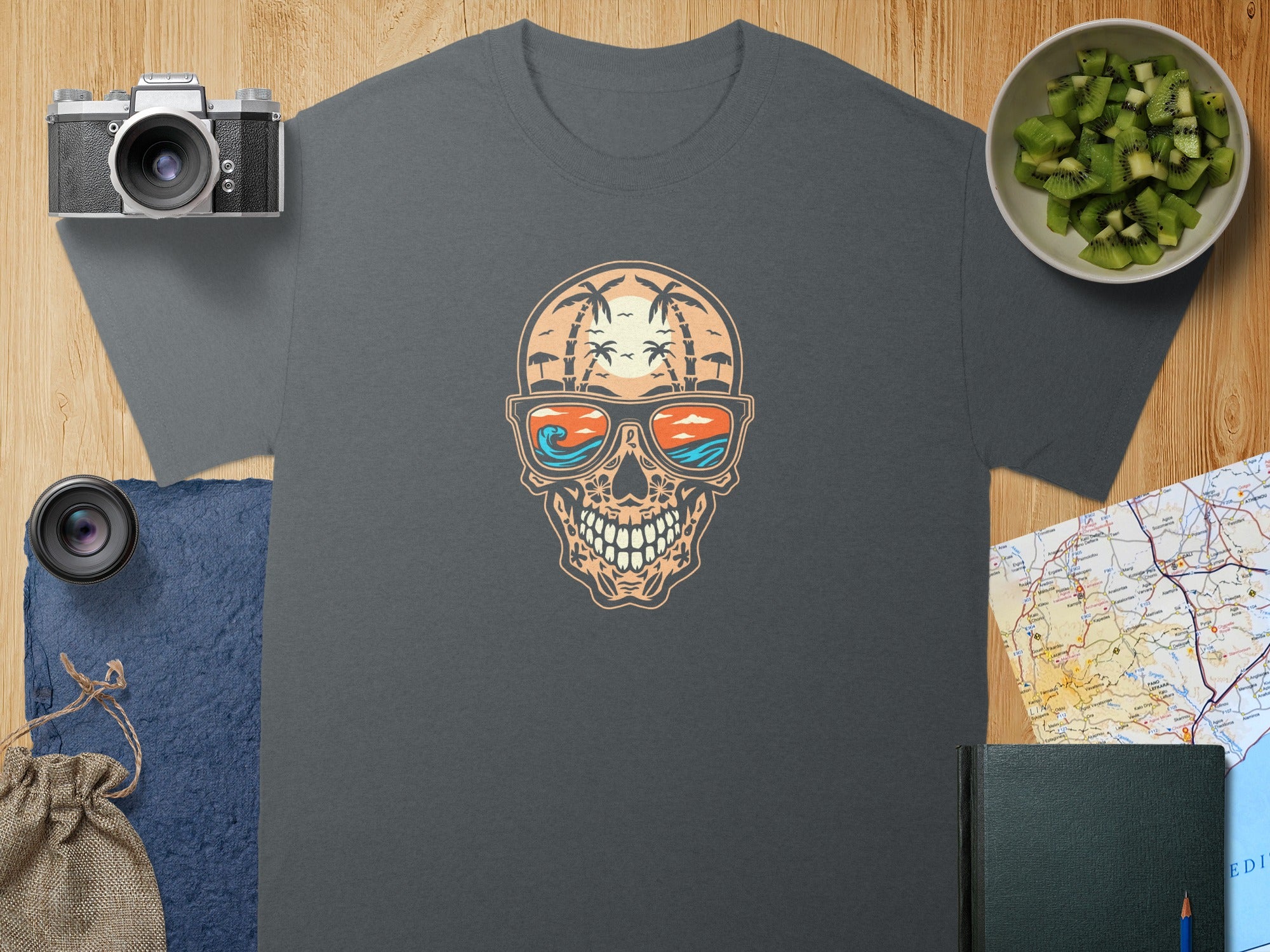 Dark grey t-shirt with skull wearing sunglasses reflecting a tropical beach scene.