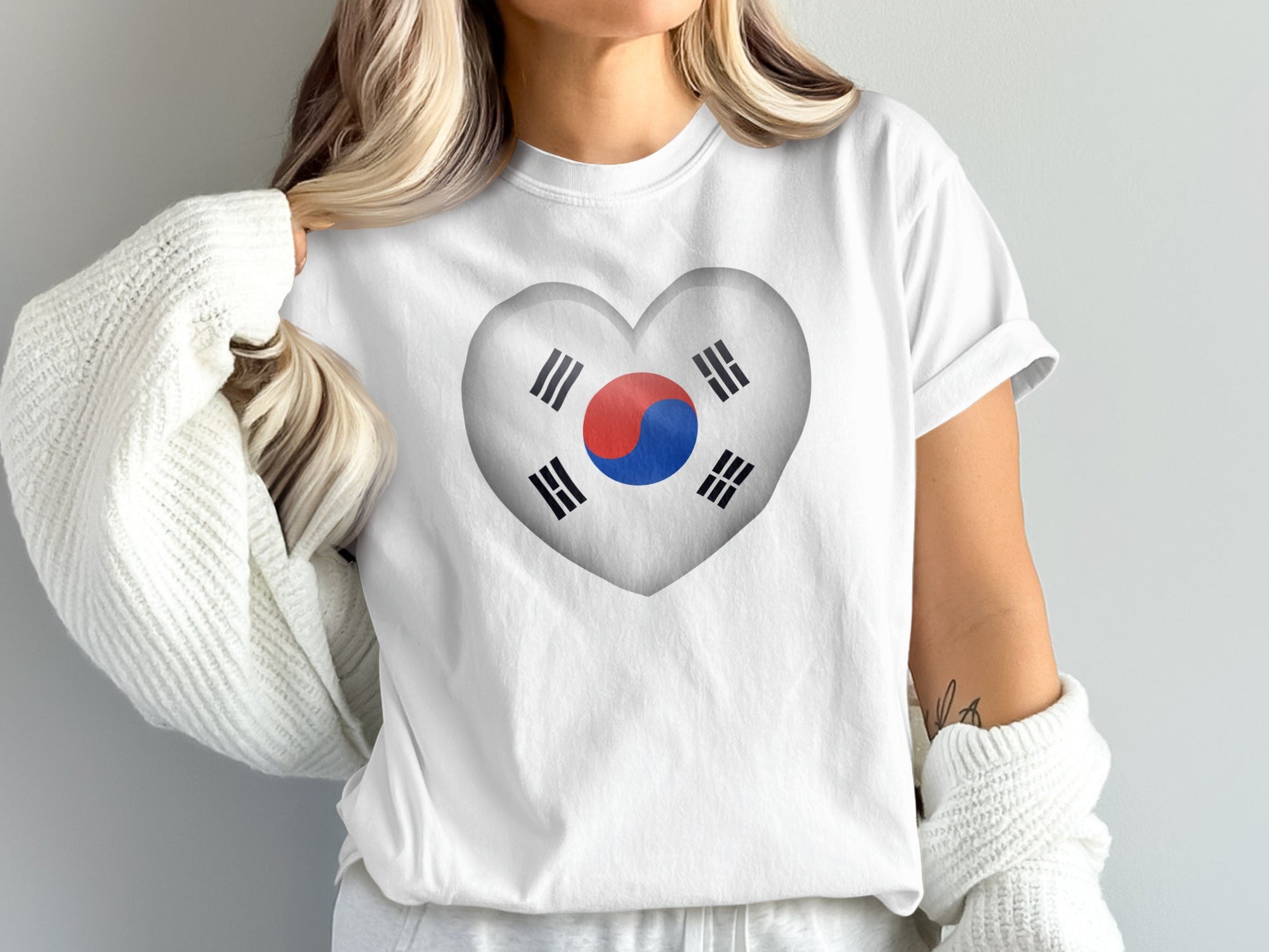 White t-shirt with a heart-shaped South Korean flag graphic.