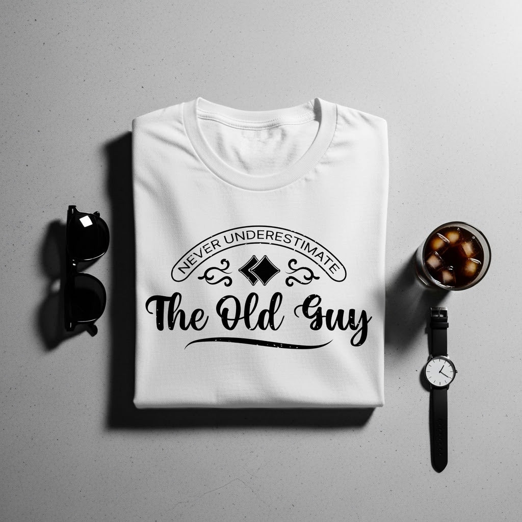 White t-shirt with black text "Never Underestimate The Old Guy" and accessories.