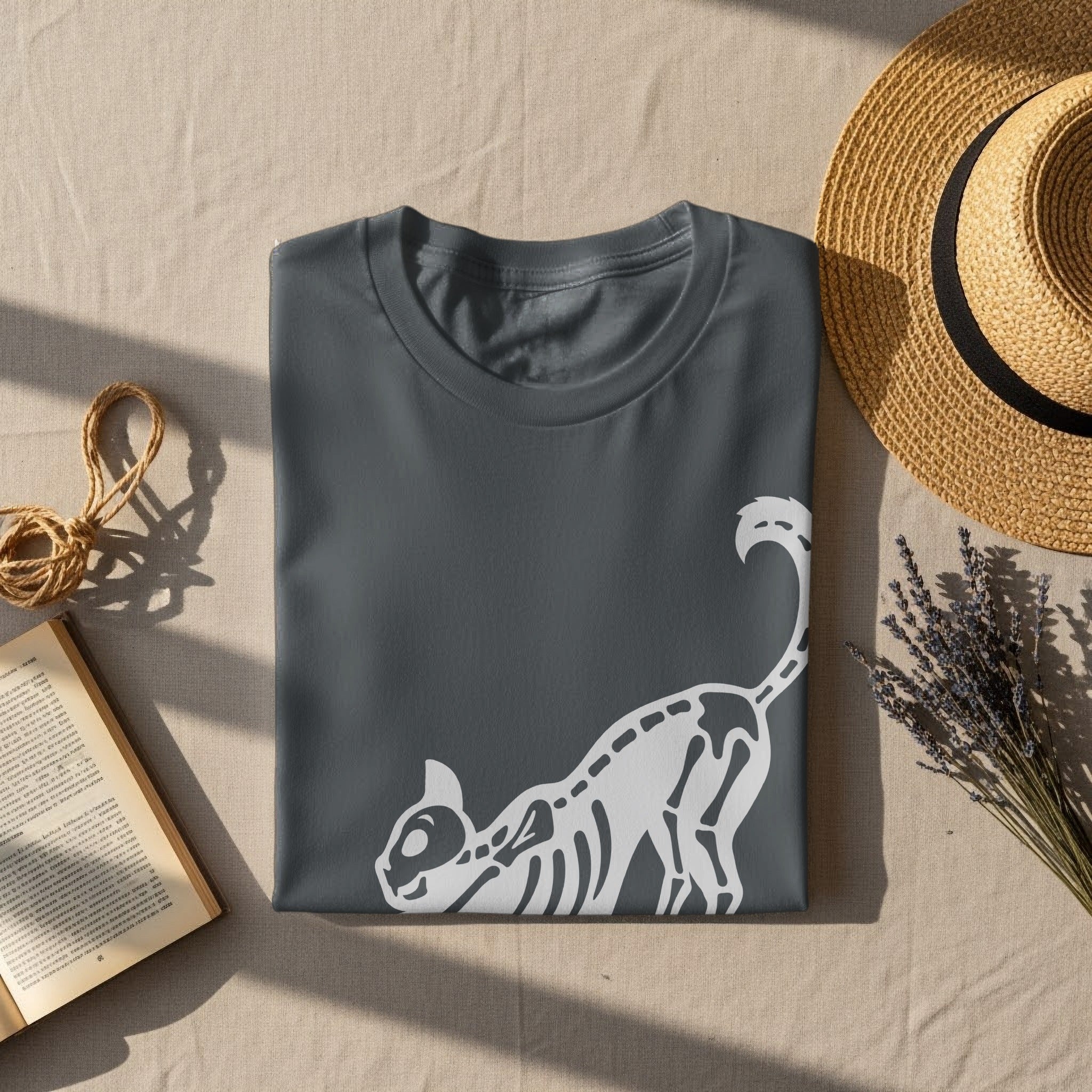 Dark gray t-shirt with white cat skeleton graphic on a neutral textured background.