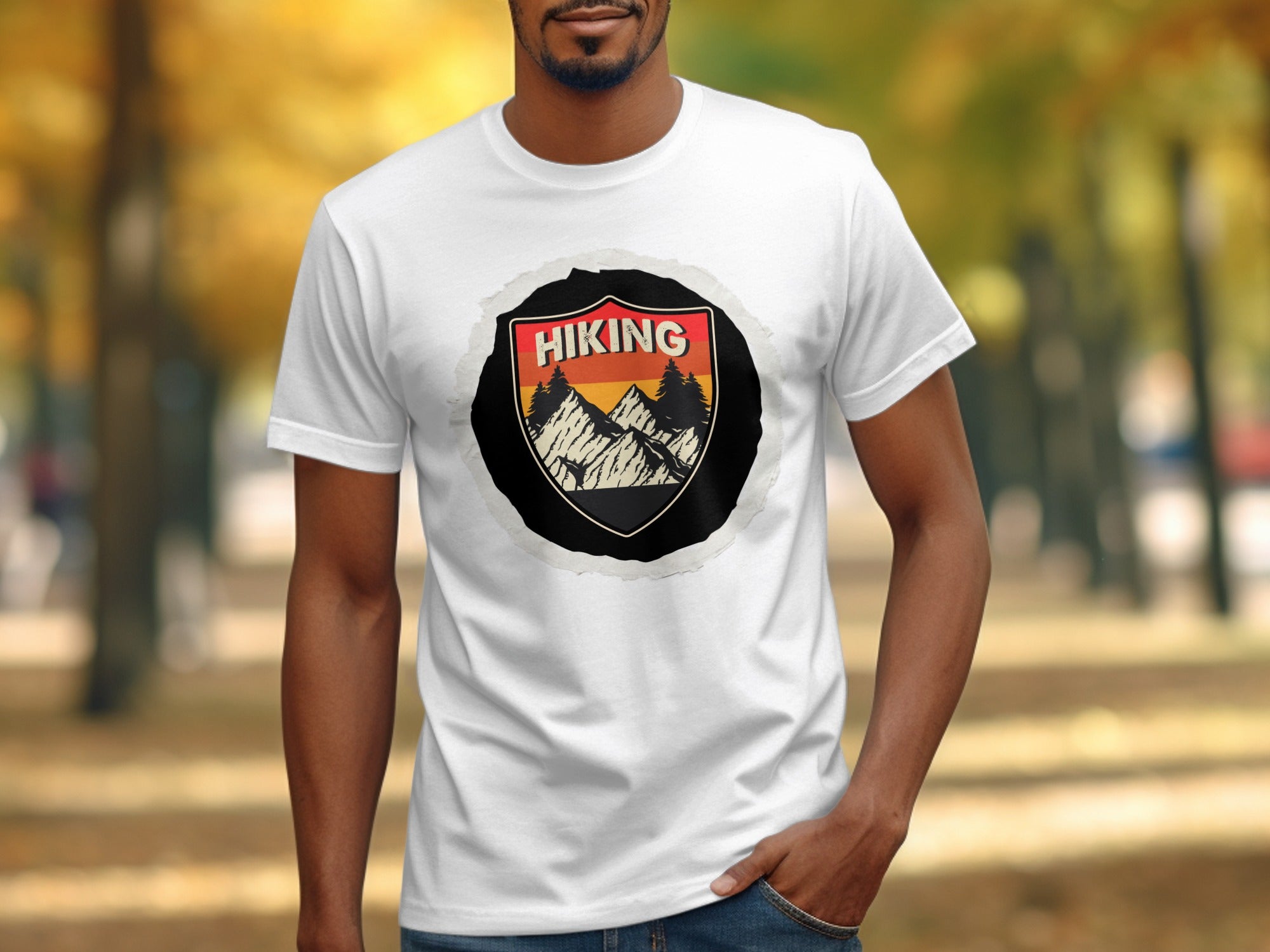 White t-shirt with a shield graphic featuring mountains, pine trees, and the word "Hiking".