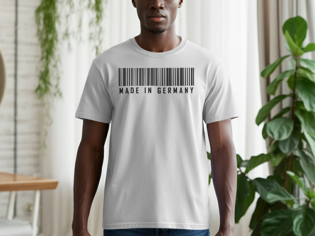 Man wearing a grey t-shirt with a black barcode and "MADE IN GERMANY" text.