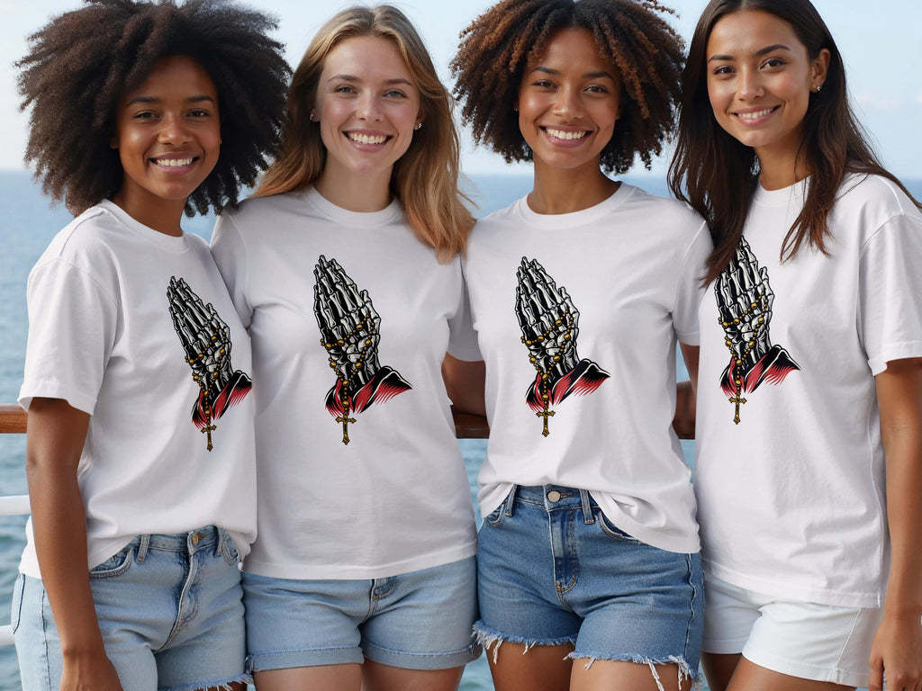 Four women wear white t-shirts with a skeleton praying hands and rosary graphic.