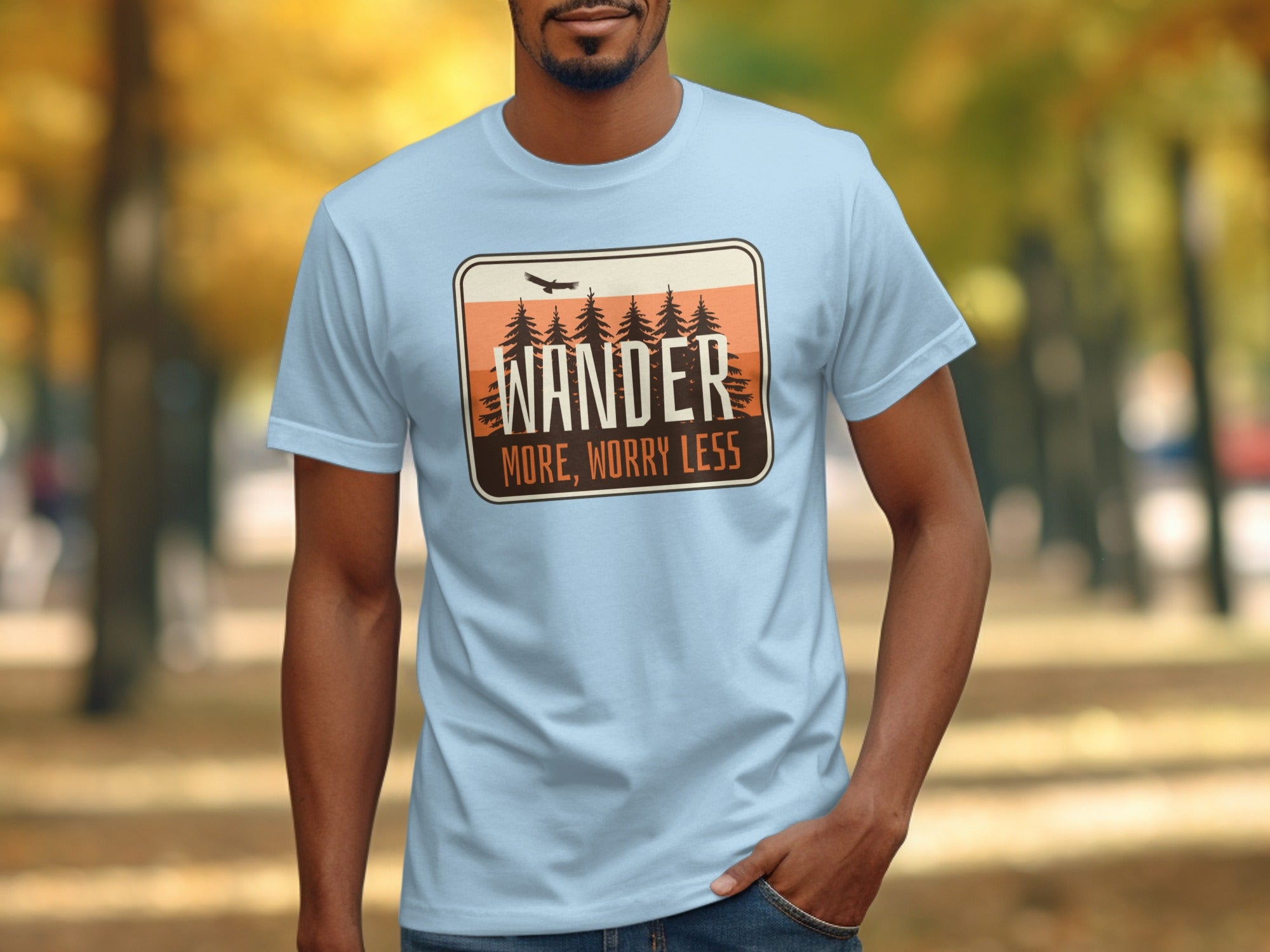 Light blue t-shirt with "Wander More, Worry Less" nature graphic.